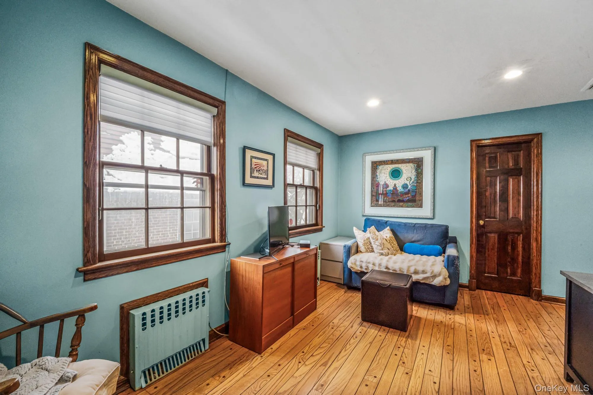 Sitting room with radiator heating unit, light wood-type flooring, and recessed lighting Sitting room with radiator heating unit, light wood-type flooring, and recessed lighting