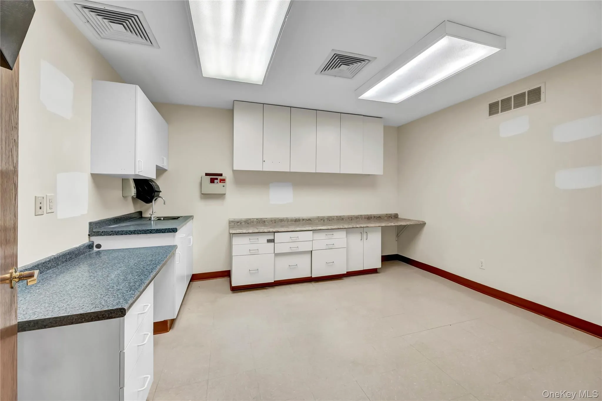Kitchen with white cabinets and dark countertops Kitchen with white cabinets and dark countertops