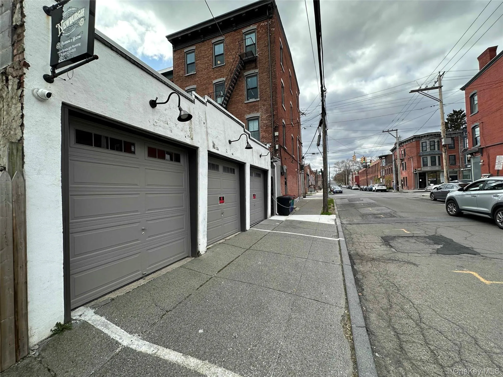View of asphalt street with sidewalks, street lights, and curbs View of asphalt street with sidewalks, street lights, and curbs