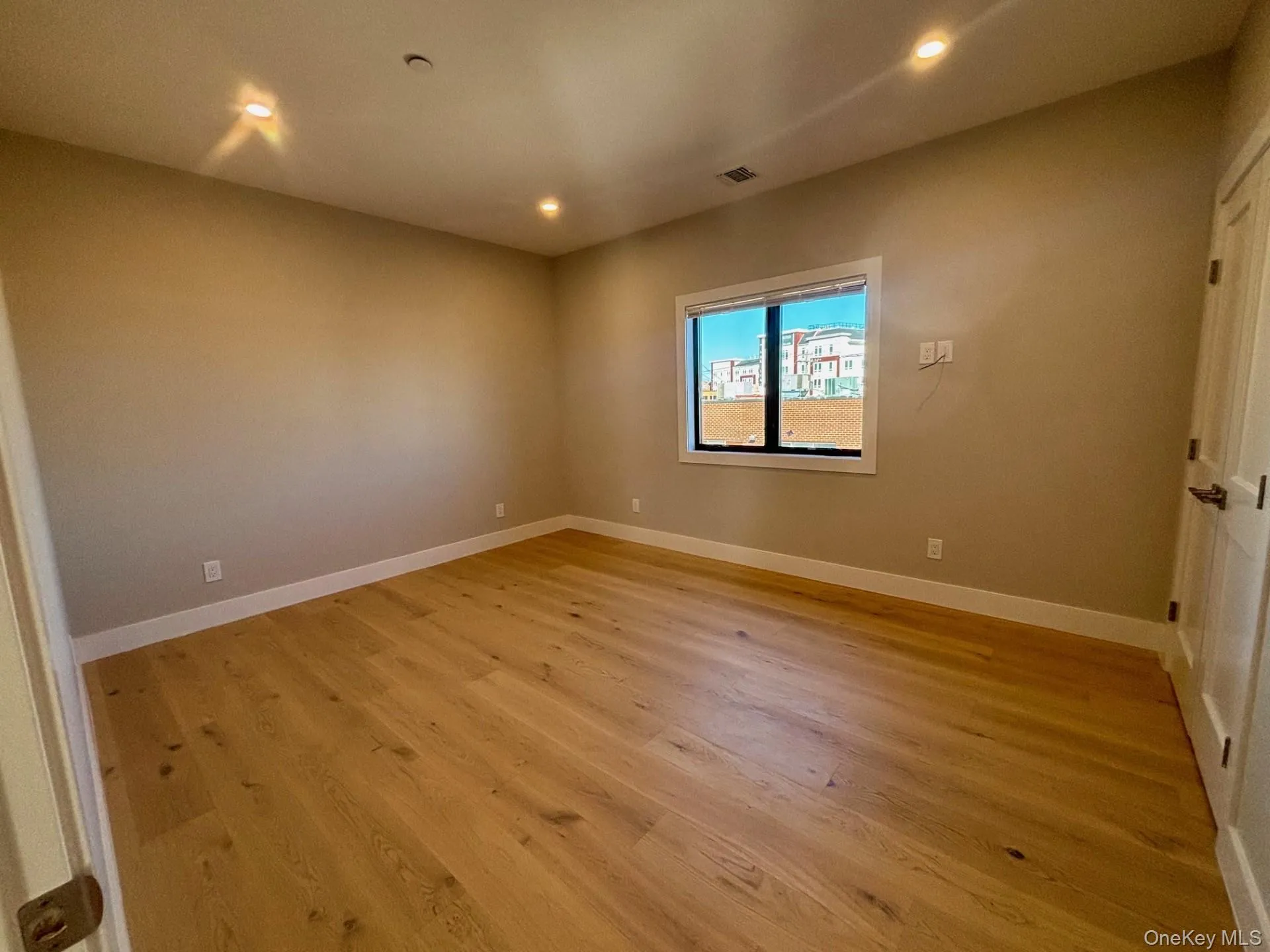 Empty room featuring light wood-style floors and recessed lighting Empty room featuring light wood-style floors and recessed lighting