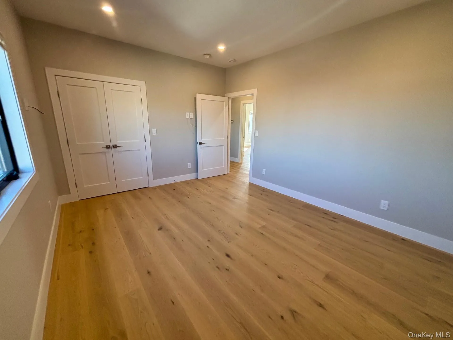 Unfurnished bedroom featuring light wood-style flooring, a closet, and recessed lighting Unfurnished bedroom featuring light wood-style flooring, a closet, and recessed lighting