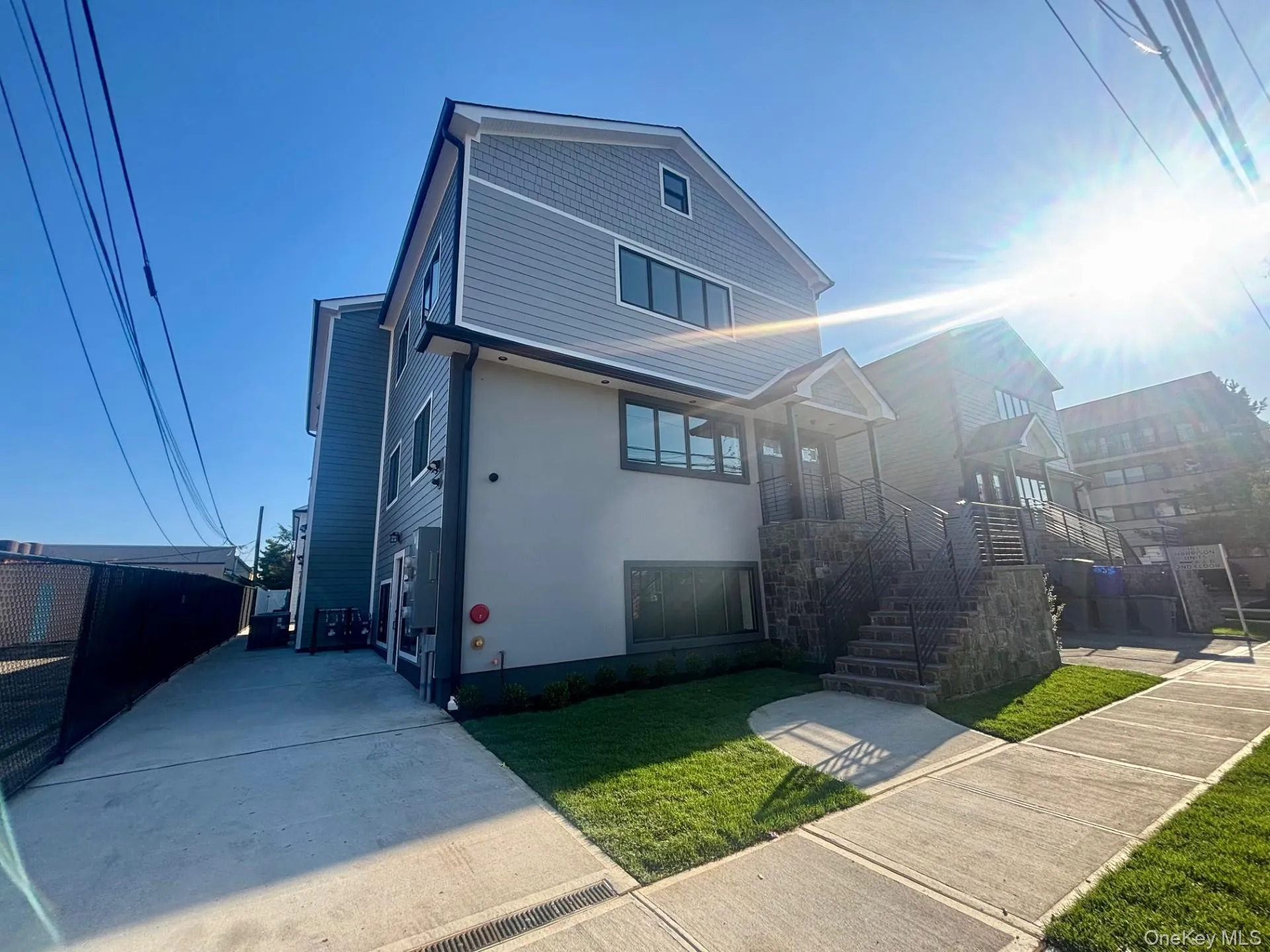 View of front facade with stairs, stucco siding, and a front lawn View of front facade with stairs, stucco siding, and a front lawn