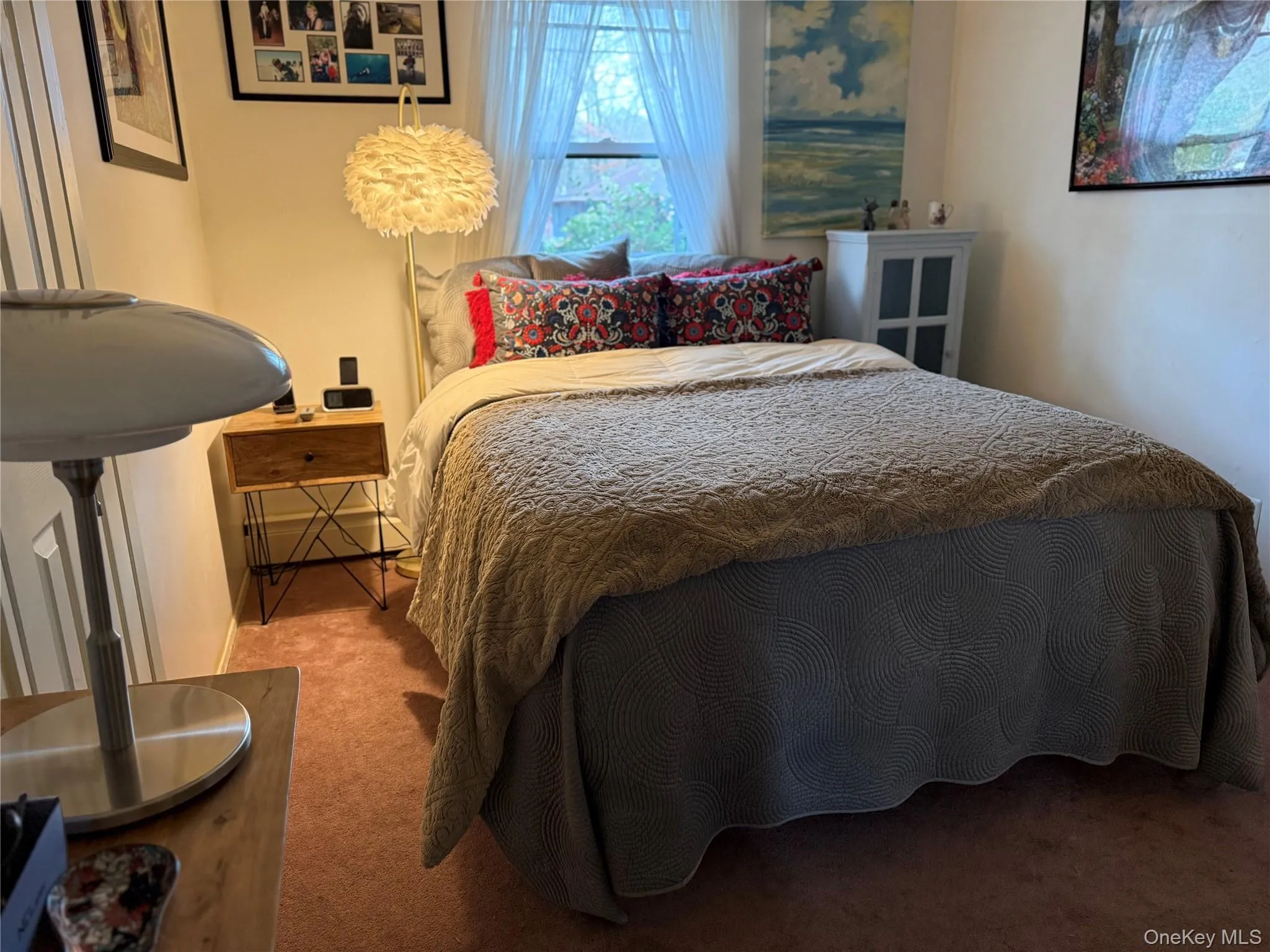 Bedroom with carpet floors and a baseboard radiator Bedroom with carpet floors and a baseboard radiator
