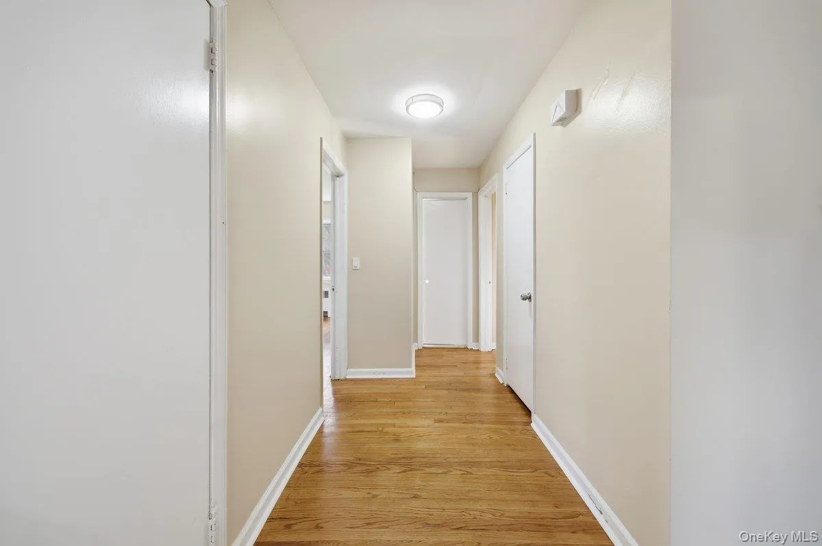 Hall featuring light wood finished floors and baseboards Hall featuring light wood finished floors and baseboards