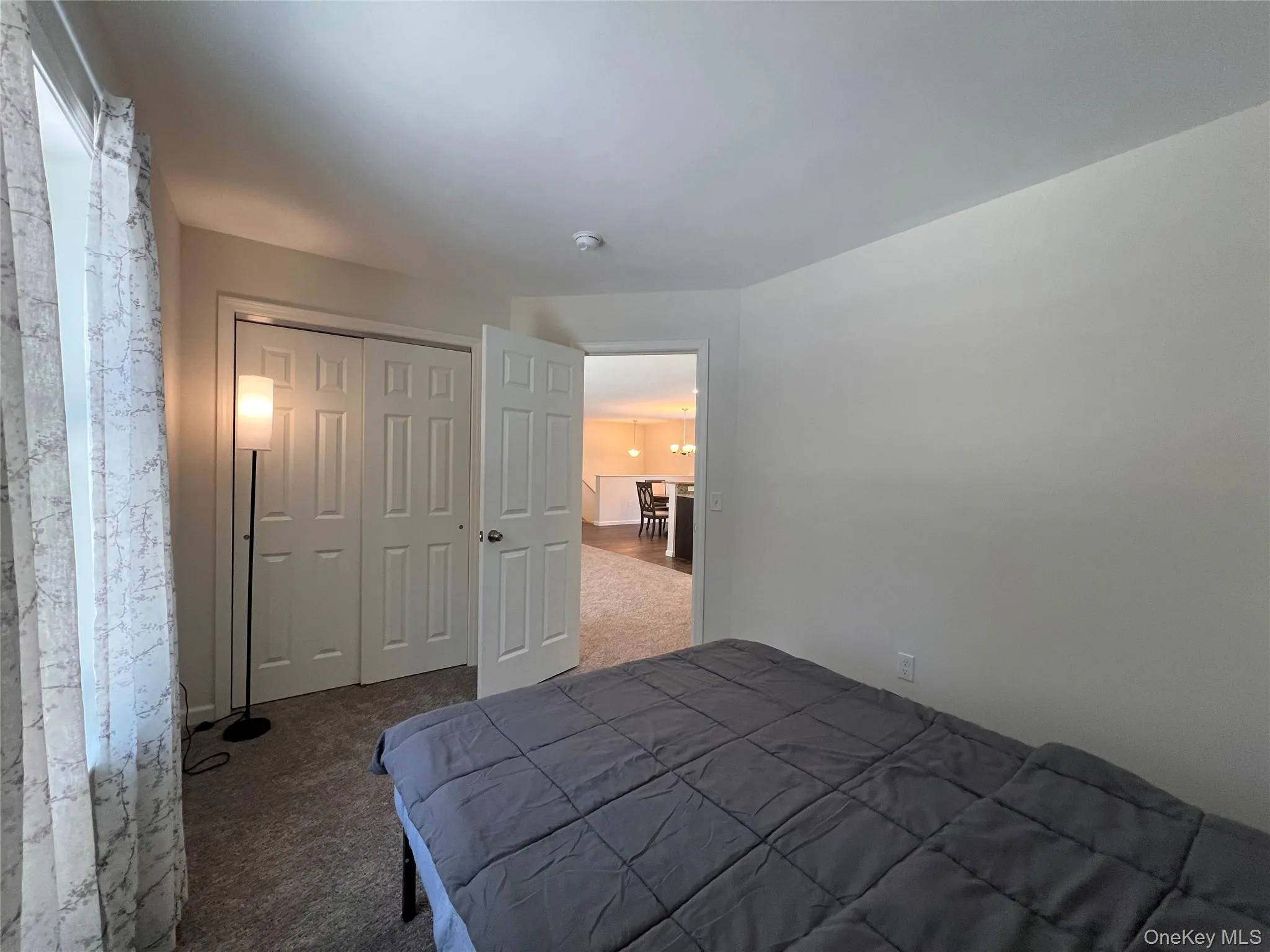 Bedroom featuring carpet and a closet Bedroom featuring carpet and a closet