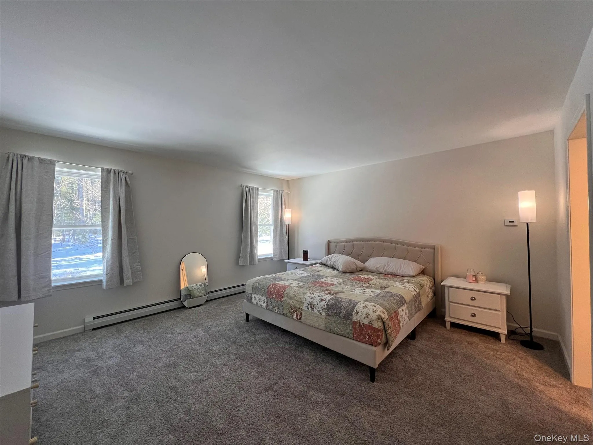 Bedroom featuring carpet and baseboard heating Bedroom featuring carpet and baseboard heating