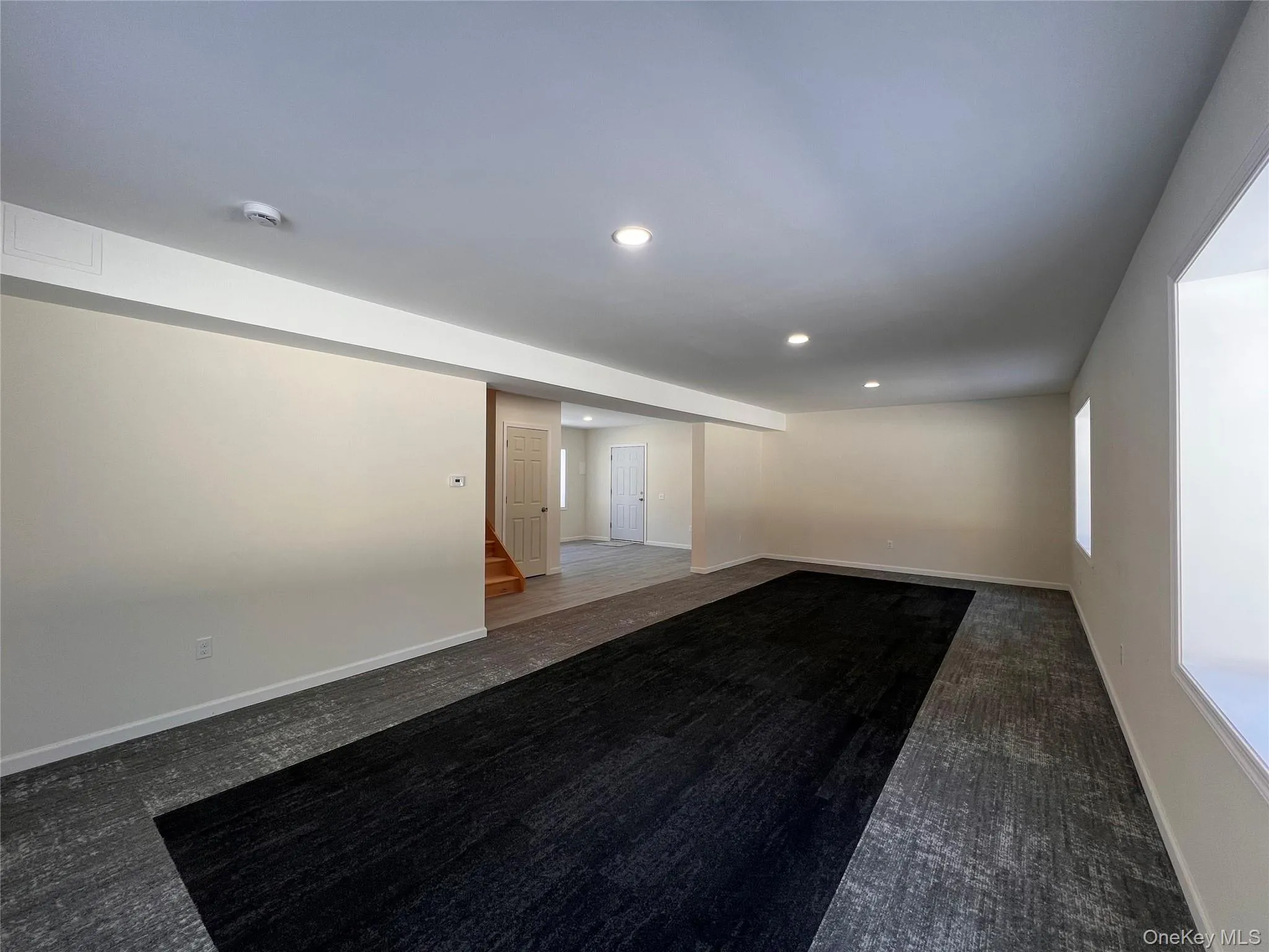 Unfurnished room featuring recessed lighting and dark carpet Unfurnished room featuring recessed lighting and dark carpet