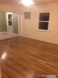 Spare room featuring dark wood-style flooring and ceiling fan Spare room featuring dark wood-style flooring and ceiling fan