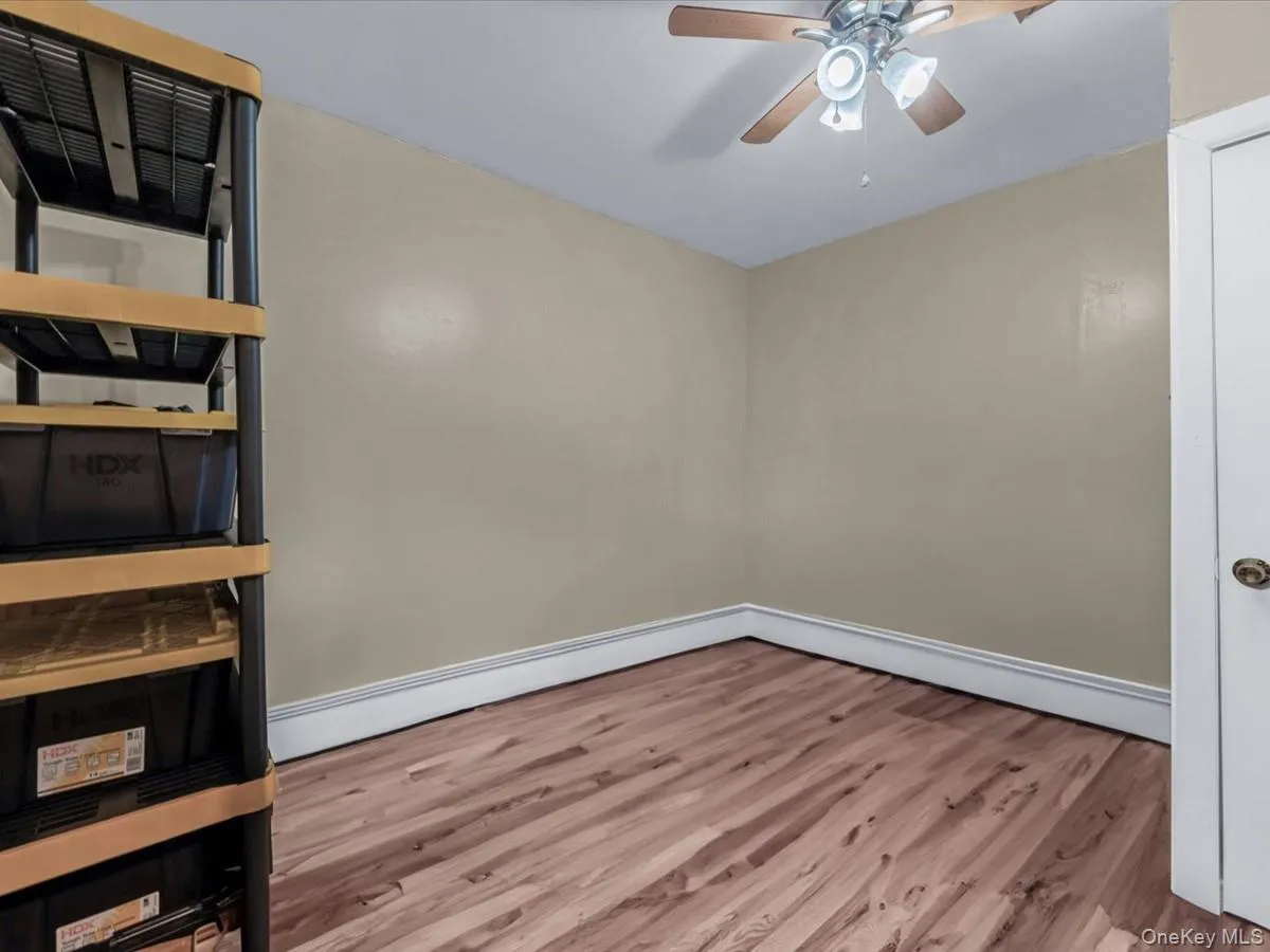 Spare room with light wood-style flooring, a baseboard heating unit, and a ceiling fan Spare room with light wood-style flooring, a baseboard heating unit, and a ceiling fan