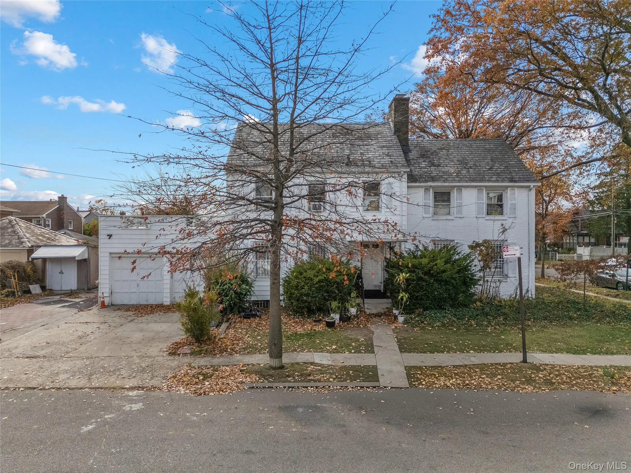 View of front of property with concrete driveway and a chimney View of front of property with concrete driveway and a chimney