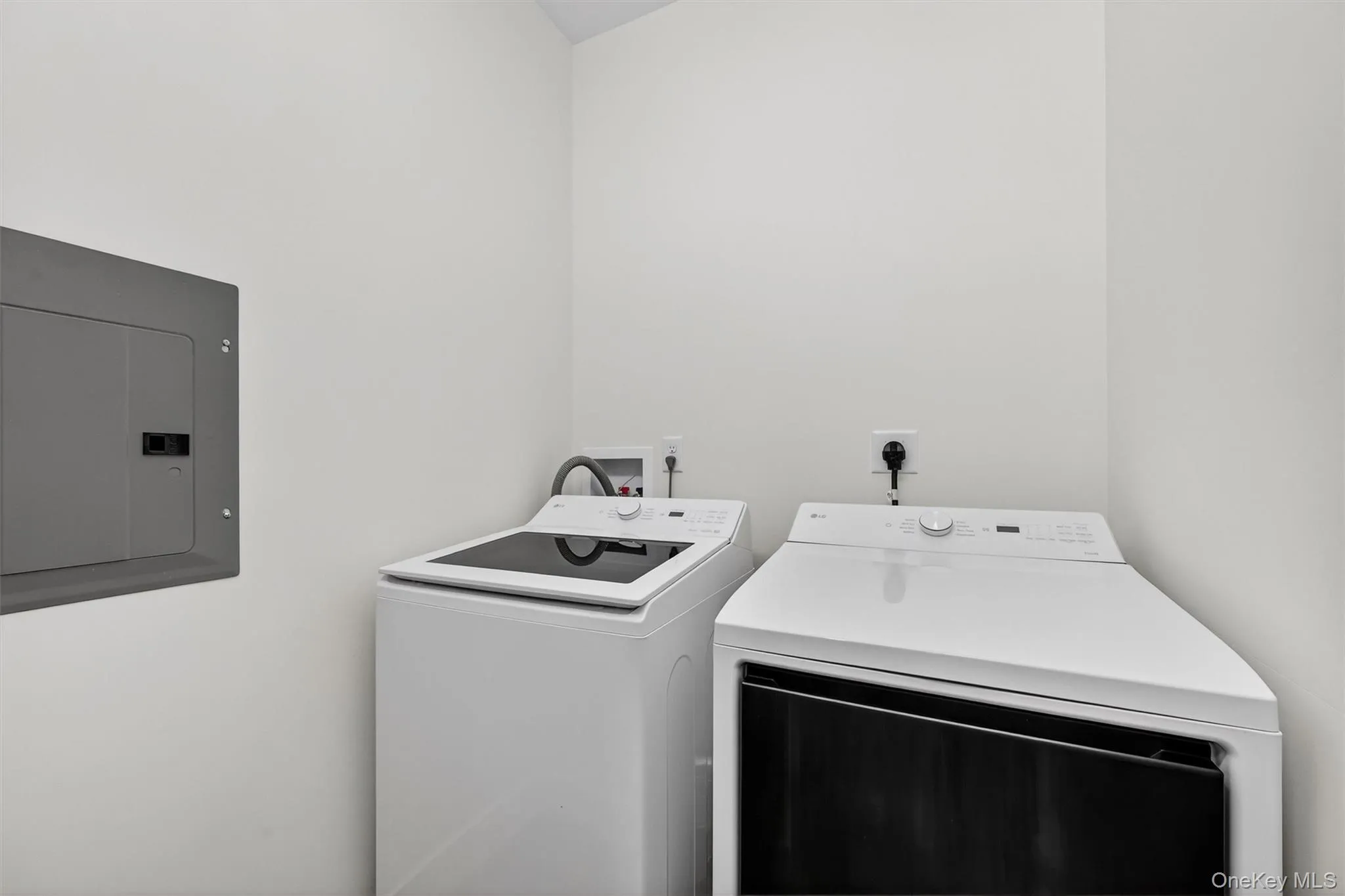Laundry room featuring electric panel and separate washer and dryer Laundry room featuring electric panel and separate washer and dryer
