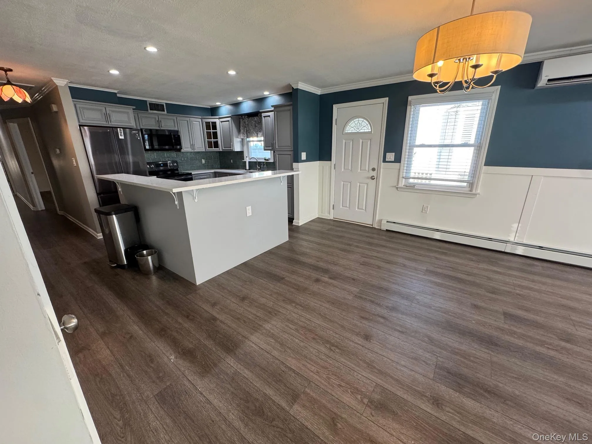 Kitchen with glass insert cabinets, pendant lighting, freestanding refrigerator, recessed lighting, and wainscoting Kitchen with glass insert cabinets, pendant lighting, freestanding refrigerator, recessed lighting, and wainscoting