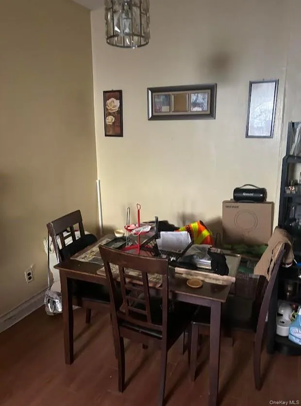 Dining space with dark wood finished floors and a chandelier Dining space with dark wood finished floors and a chandelier