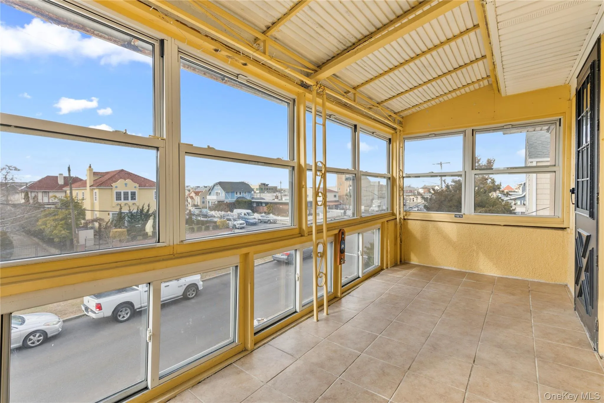 Unfurnished sunroom with a residential view Unfurnished sunroom with a residential view