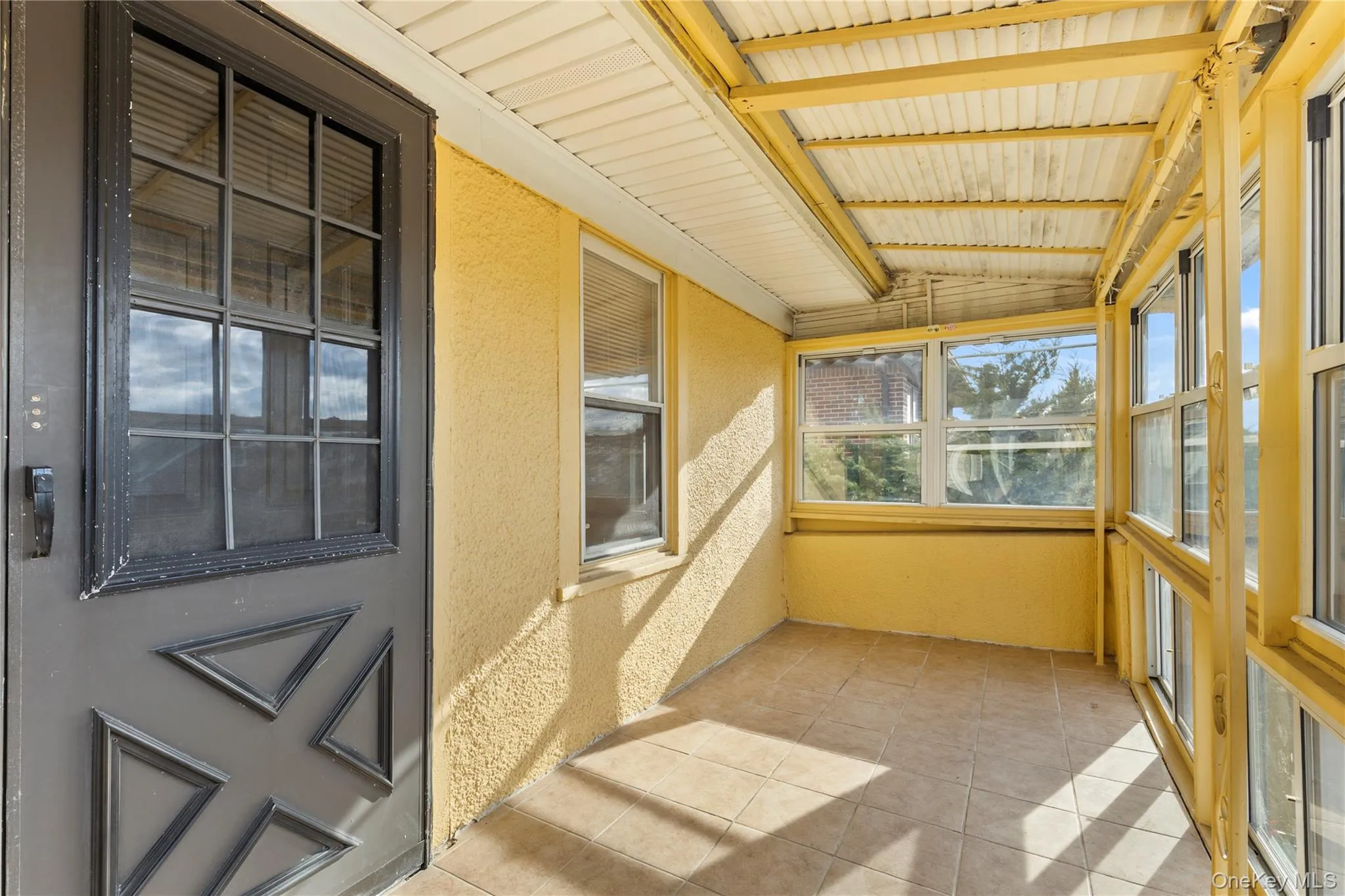 Unfurnished sunroom featuring vaulted ceiling Unfurnished sunroom featuring vaulted ceiling