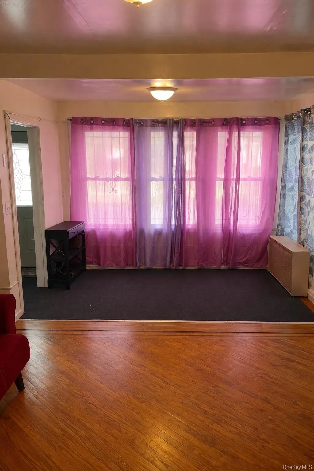 Unfurnished room with healthy amount of natural light and wood finished floors Unfurnished room with healthy amount of natural light and wood finished floors