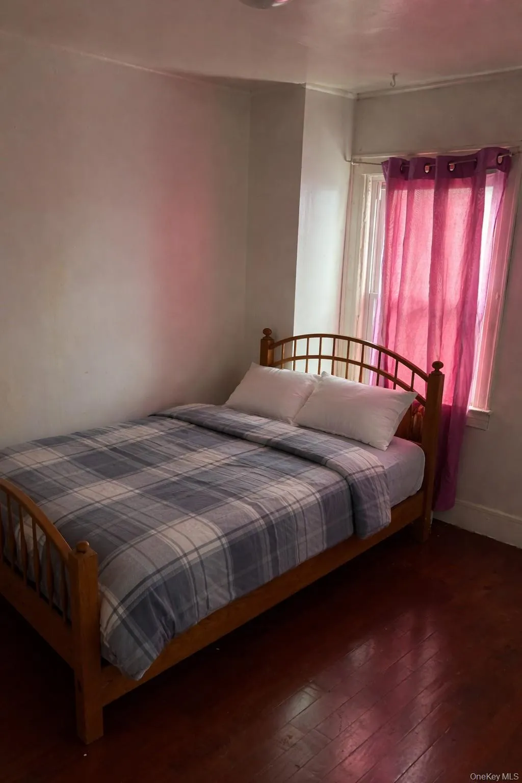 Bedroom featuring wood-type flooring and baseboards Bedroom featuring wood-type flooring and baseboards