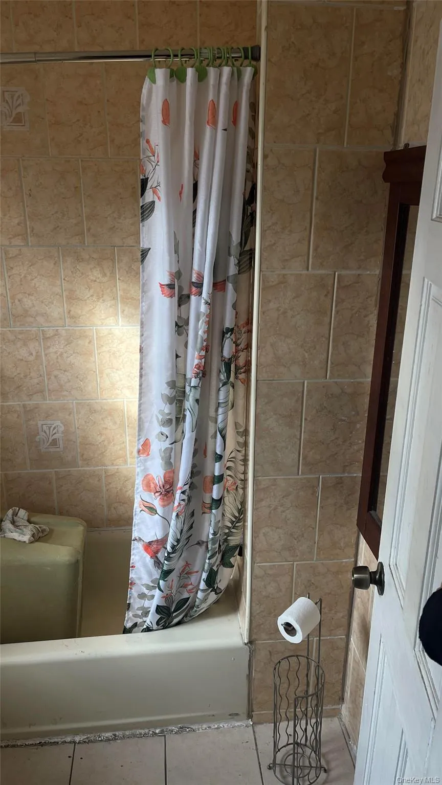 Full bath featuring shower / bath combination with curtain Full bath featuring shower / bath combination with curtain