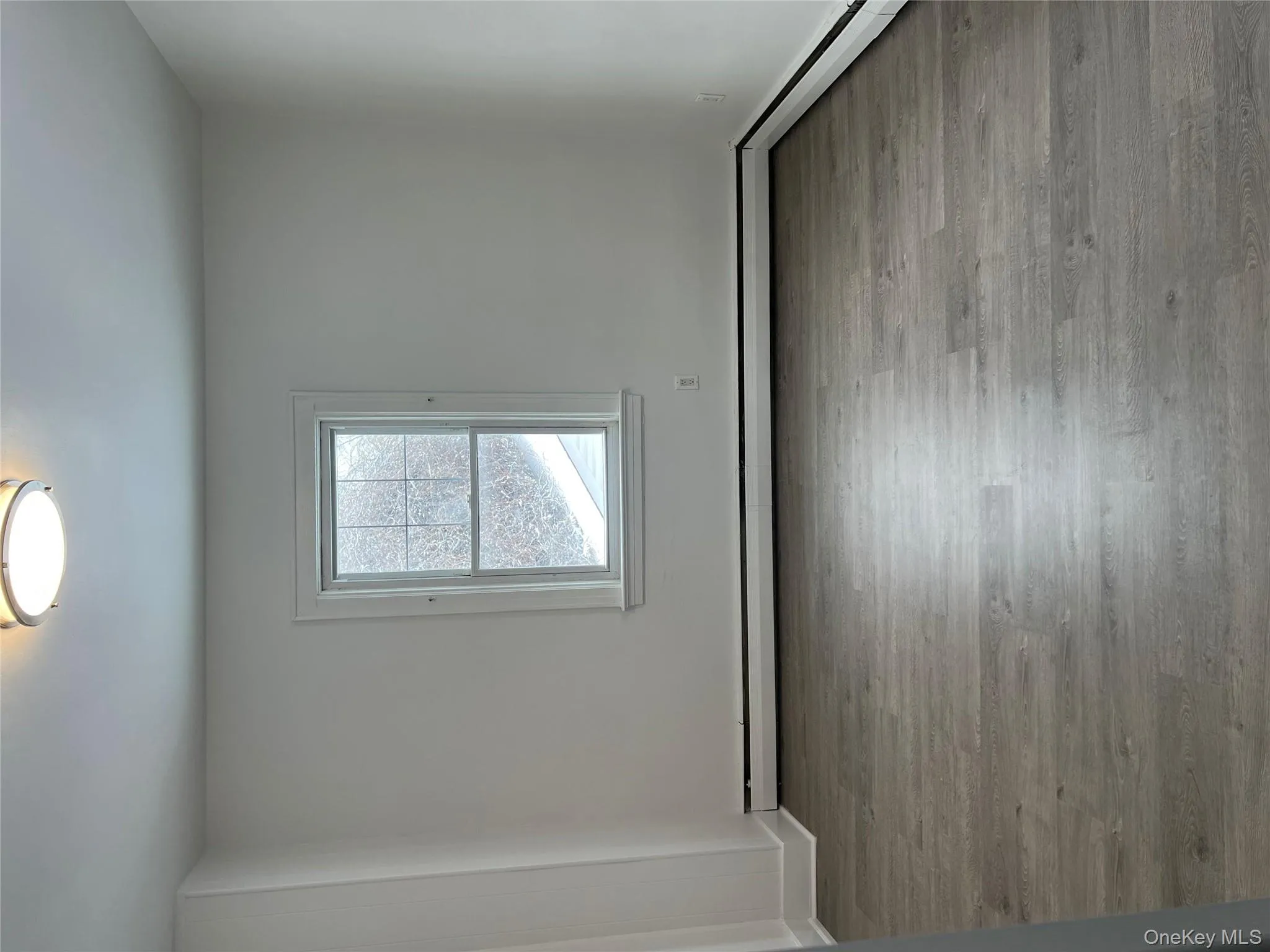 Empty room featuring light wood-style floors and a baseboard radiator Empty room featuring light wood-style floors and a baseboard radiator