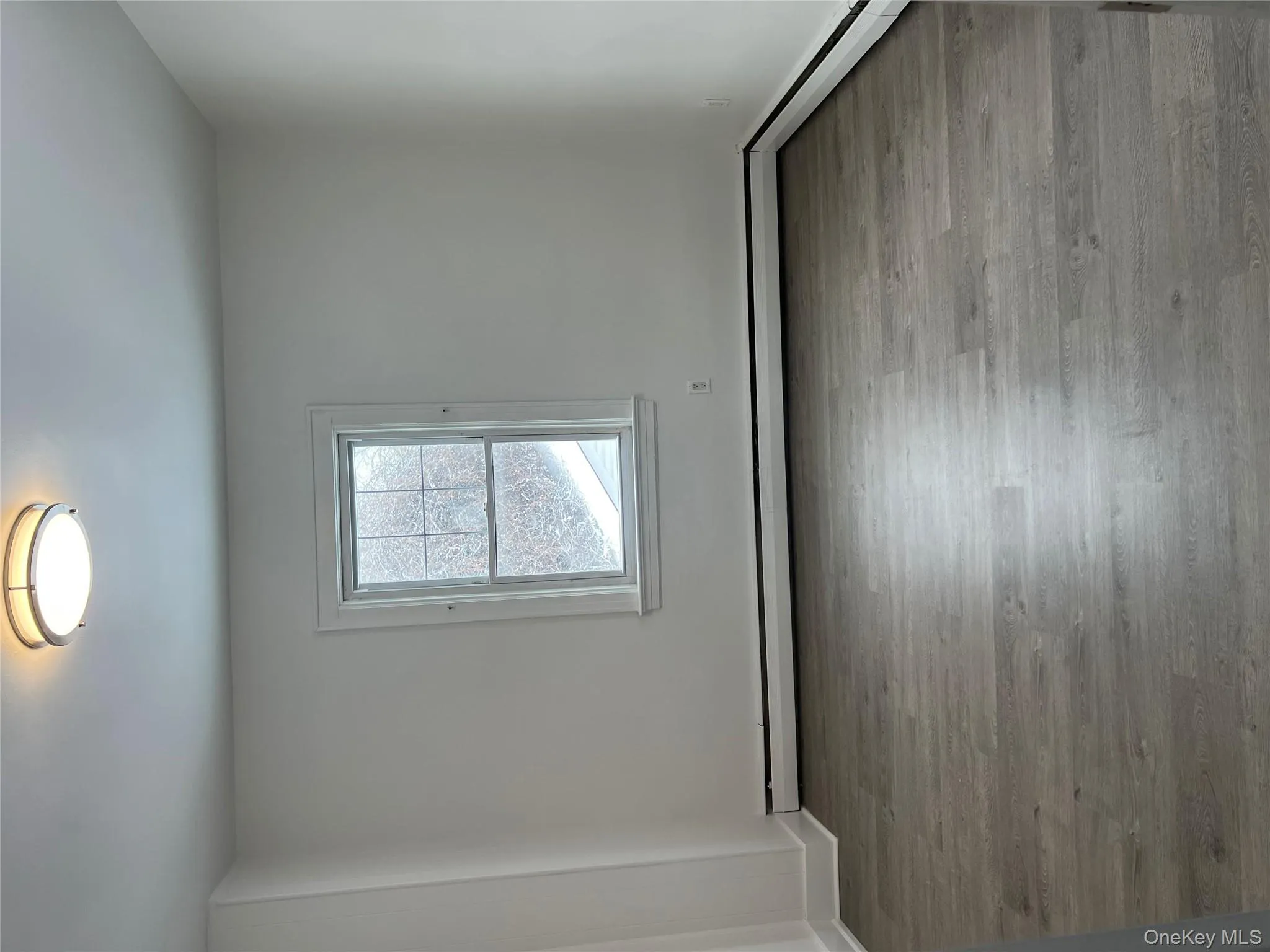Unfurnished room featuring light wood-style flooring and a baseboard heating unit Unfurnished room featuring light wood-style flooring and a baseboard heating unit