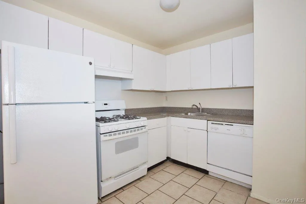 Kitchen with white appliances - gas stove/oven, fridge, dishwasher, counter/cabinets finishes may vary Kitchen with white appliances - gas stove/oven, fridge, dishwasher, counter/cabinets finishes may vary