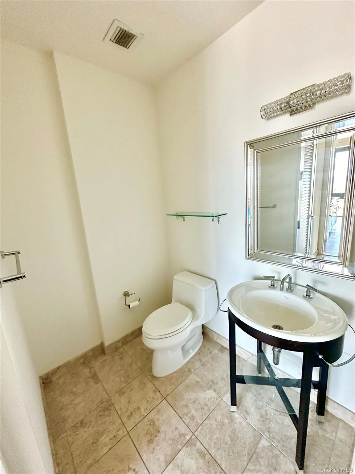 Half bath featuring toilet and light tile patterned floors Half bath featuring toilet and light tile patterned floors
