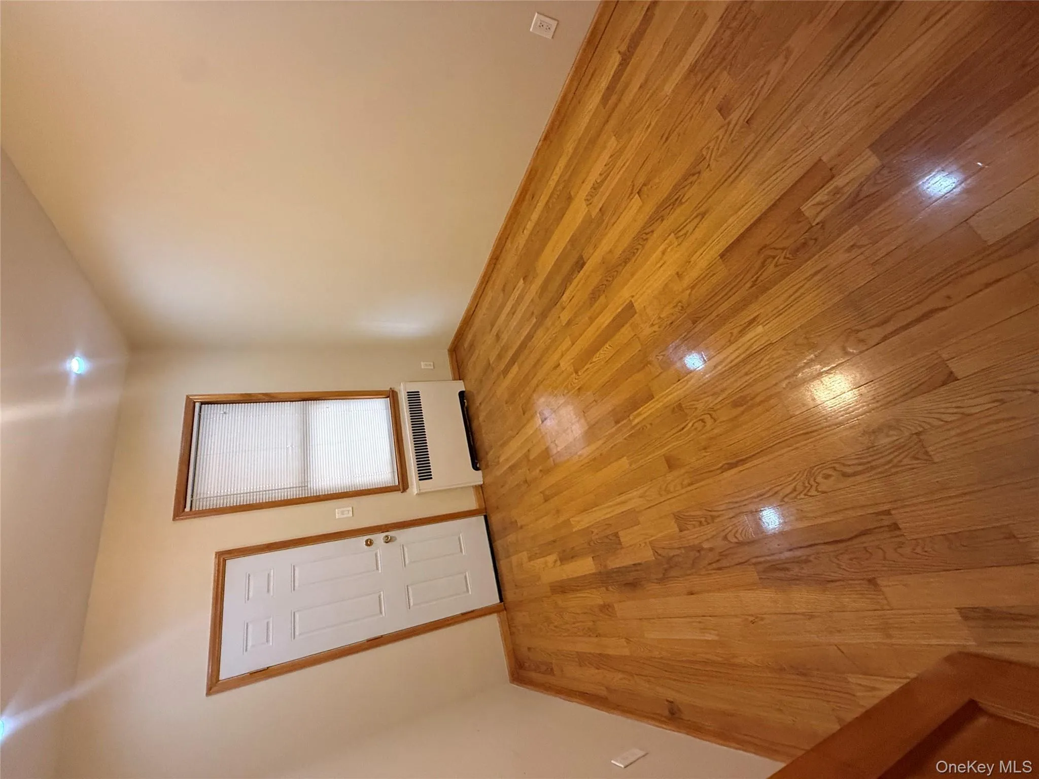 Unfurnished room with light wood-type flooring and radiator heating unit Unfurnished room with light wood-type flooring and radiator heating unit