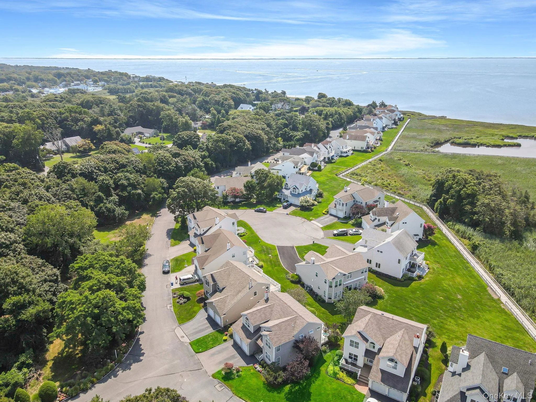 Aerial view of residential area featuring a nearby body of water Aerial view of residential area featuring a nearby body of water