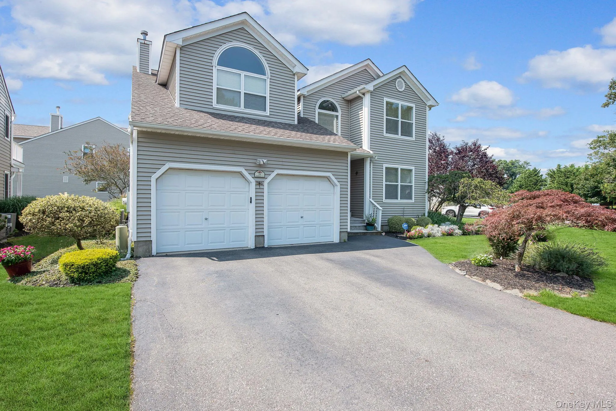 Traditional-style home with driveway, a front yard, a shingled roof, and a chimney Traditional-style home with driveway, a front yard, a shingled roof, and a chimney