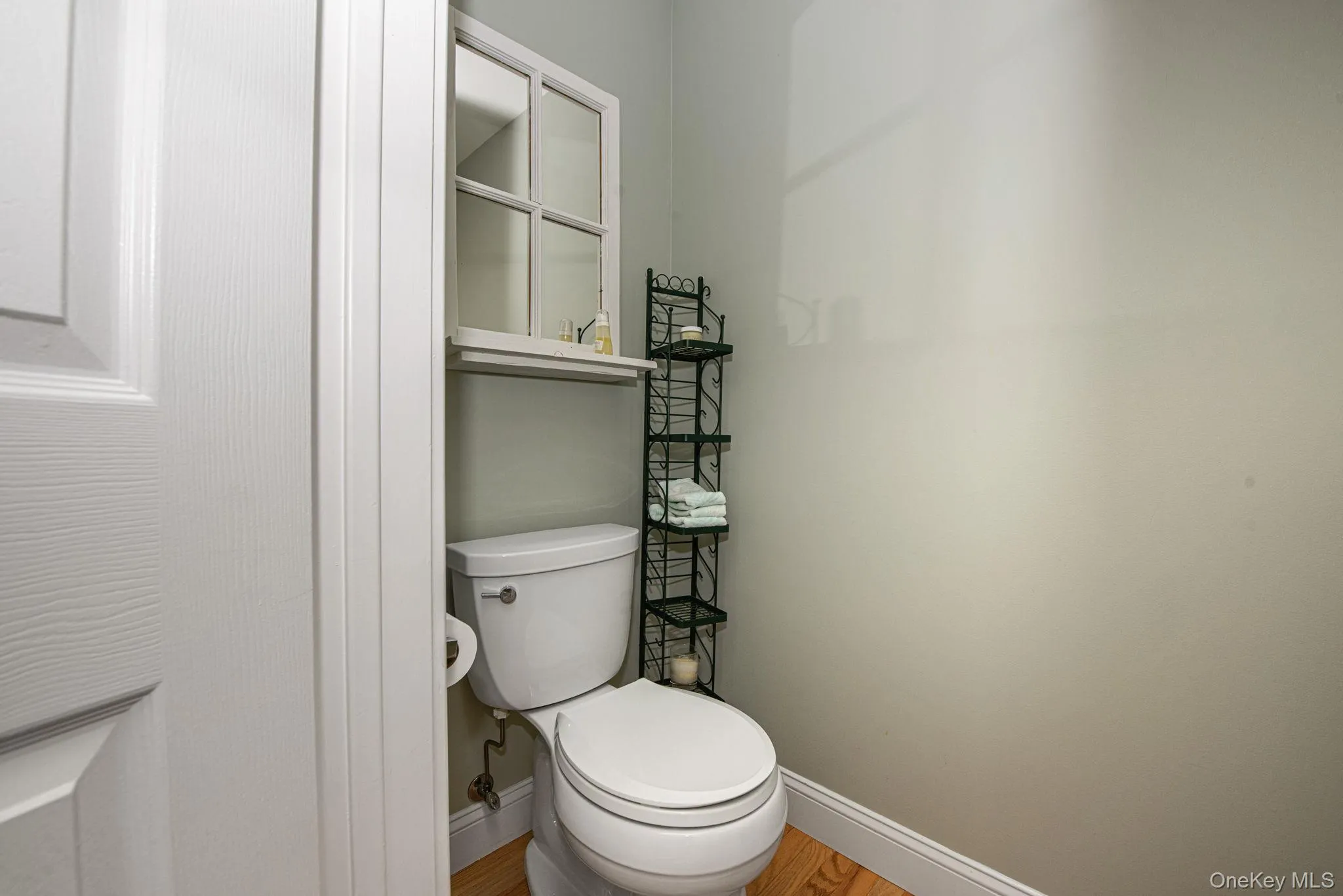 Bathroom with baseboards and wood finished floors Bathroom with baseboards and wood finished floors