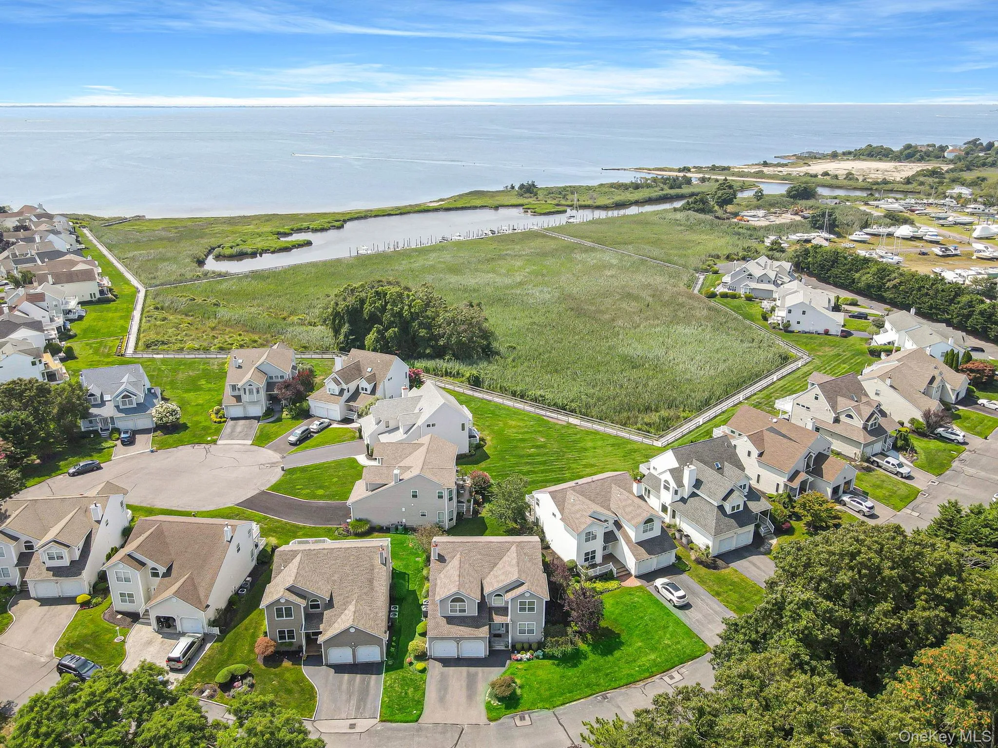Aerial view of property and surrounding area with nearby suburban area and a large body of water Aerial view of property and surrounding area with nearby suburban area and a large body of water