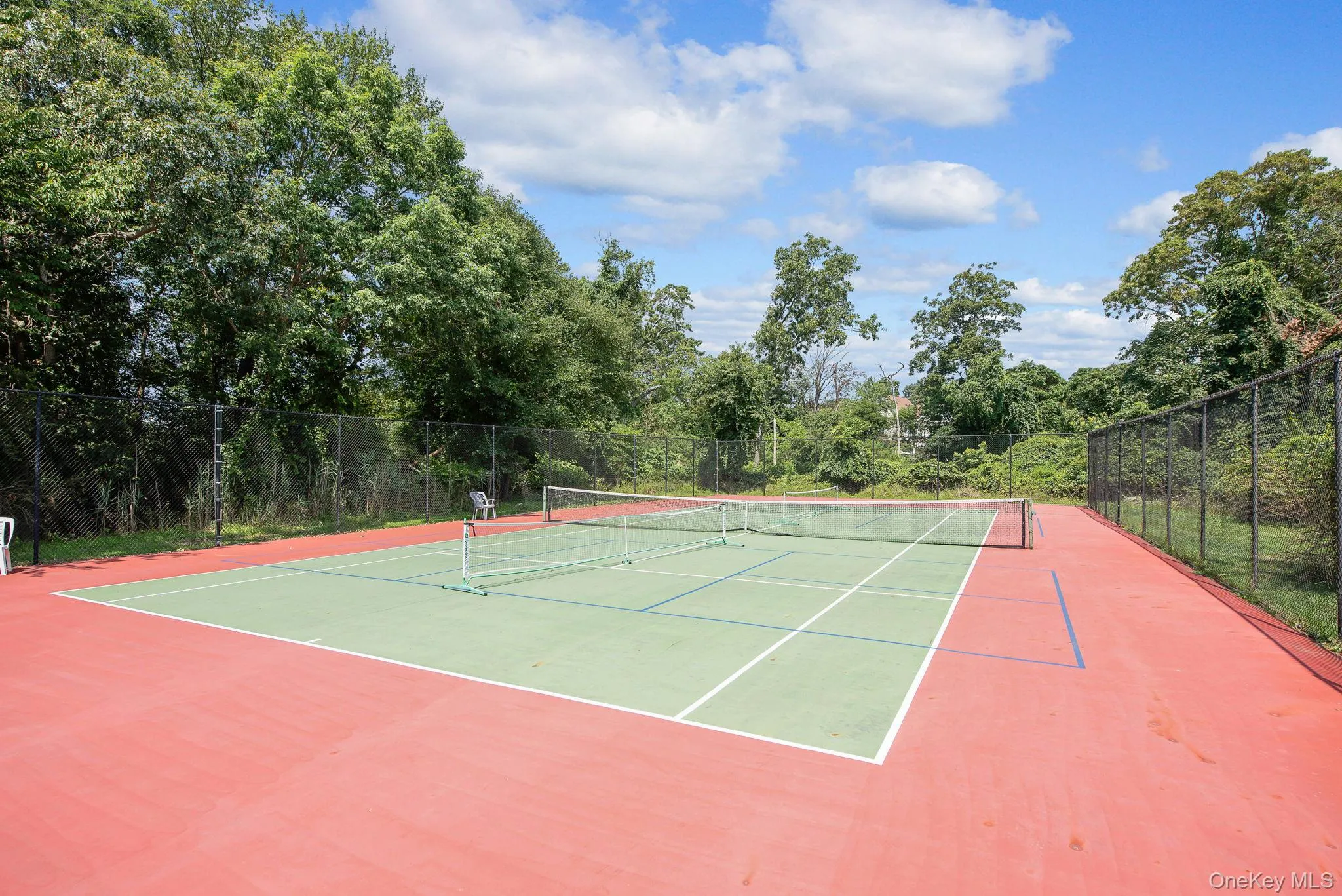 View of tennis court with community basketball court View of tennis court with community basketball court