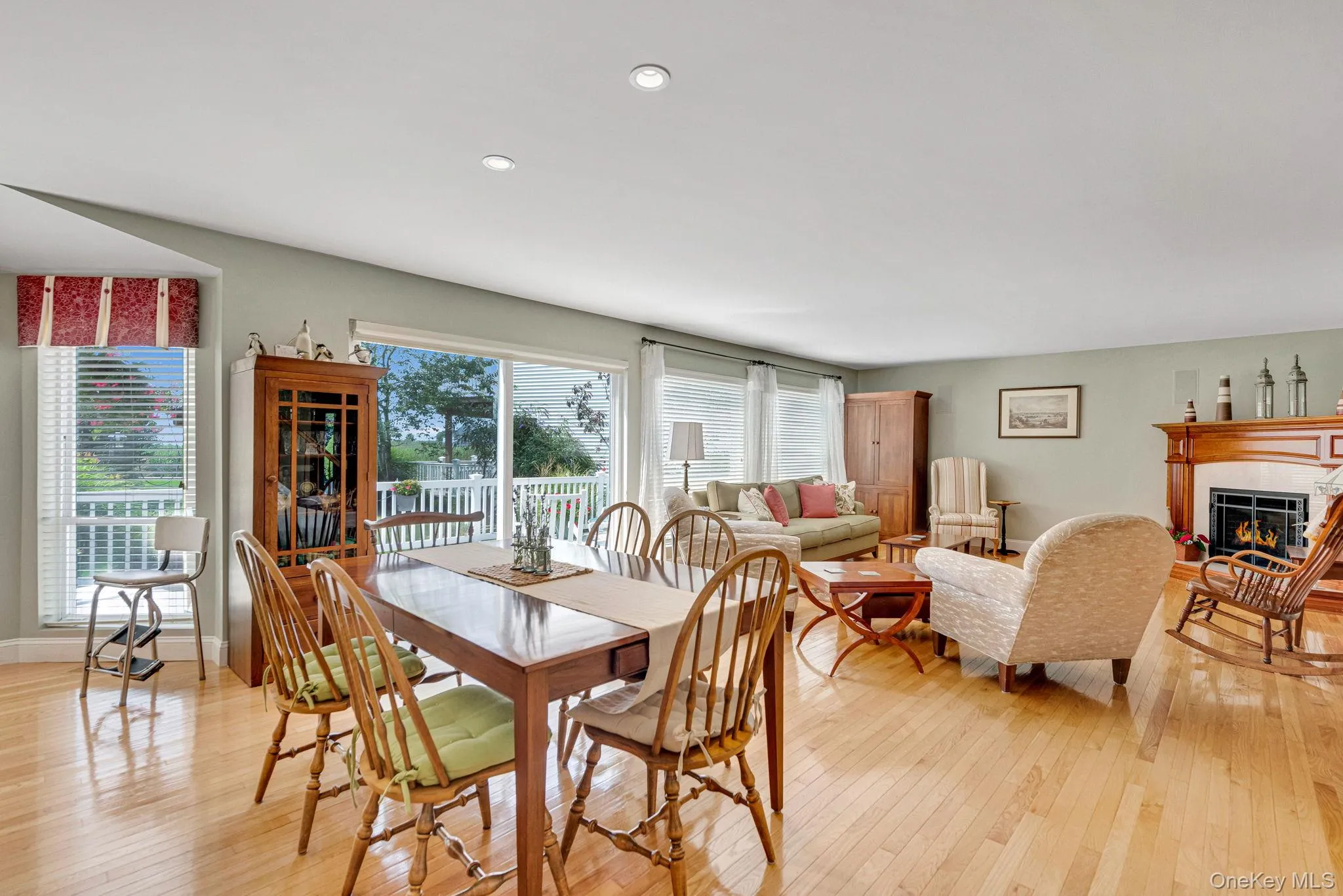 Dining area featuring a glass covered fireplace and light wood finished floors Dining area featuring a glass covered fireplace and light wood finished floors