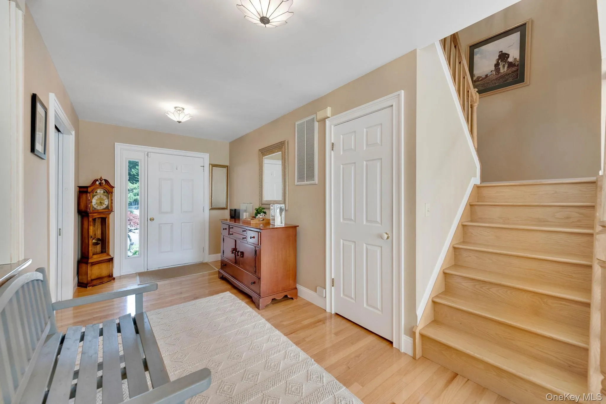 Entryway with stairway and light wood finished floors Entryway with stairway and light wood finished floors