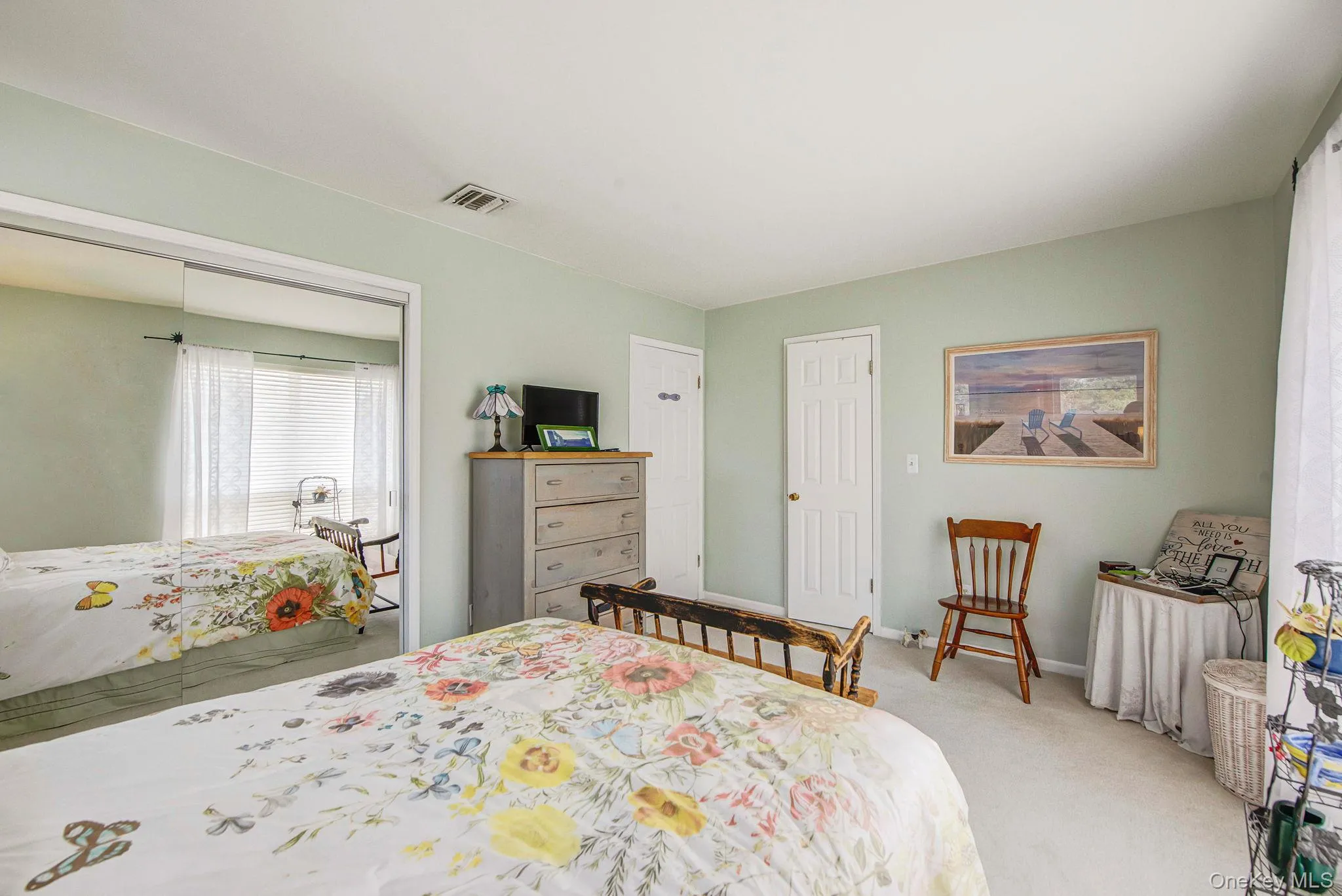 Bedroom with light colored carpet and a closet Bedroom with light colored carpet and a closet