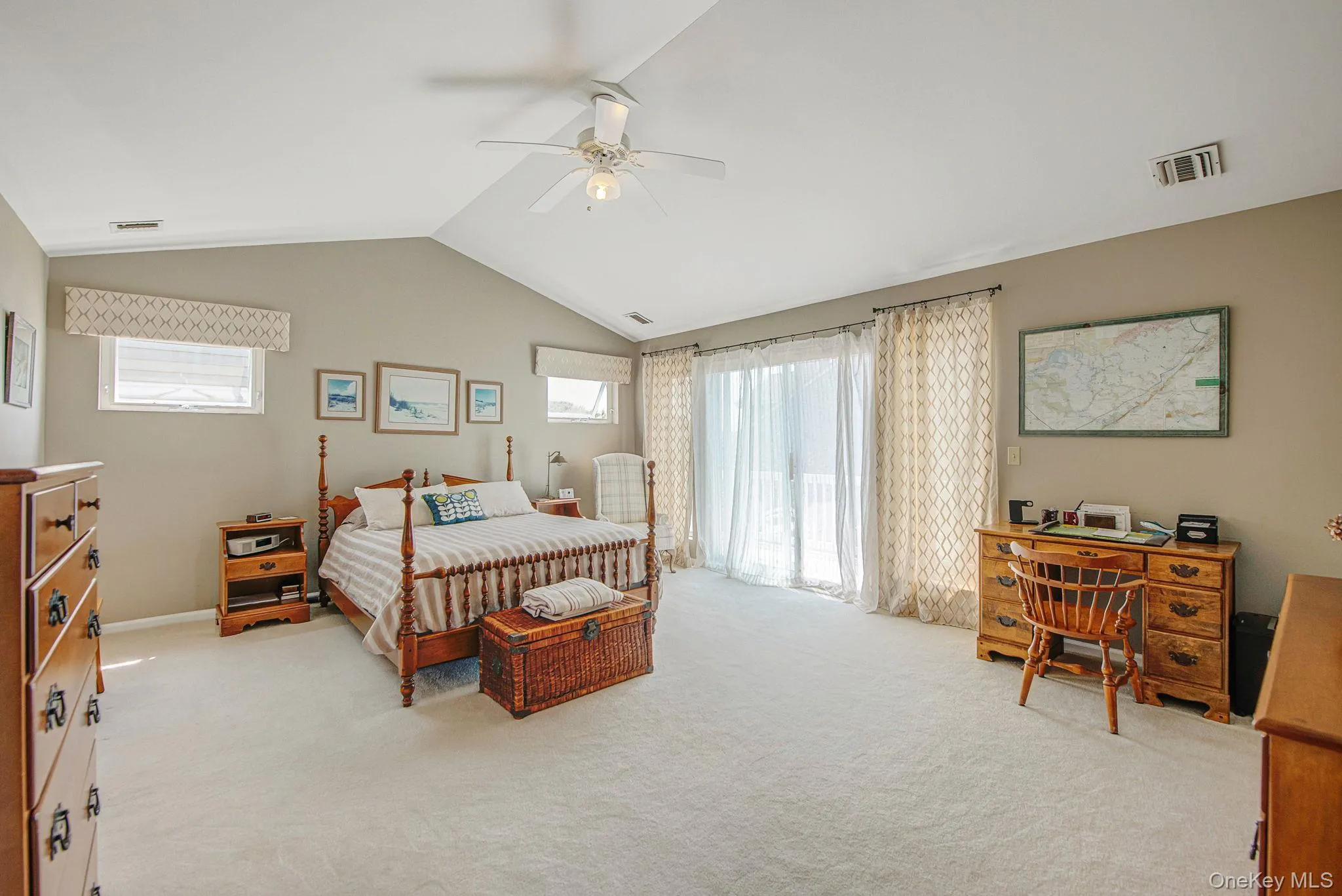 Bedroom with light colored carpet, lofted ceiling, access to exterior, ceiling fan, and an office area Bedroom with light colored carpet, lofted ceiling, access to exterior, ceiling fan, and an office area