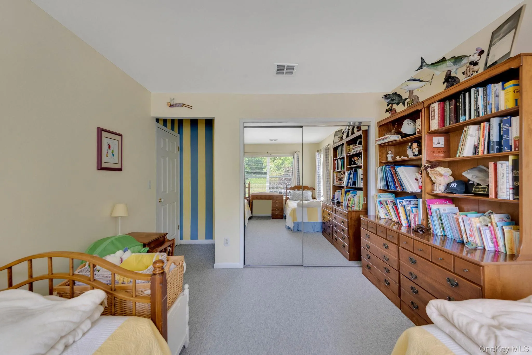 Bedroom featuring light carpet and a closet Bedroom featuring light carpet and a closet
