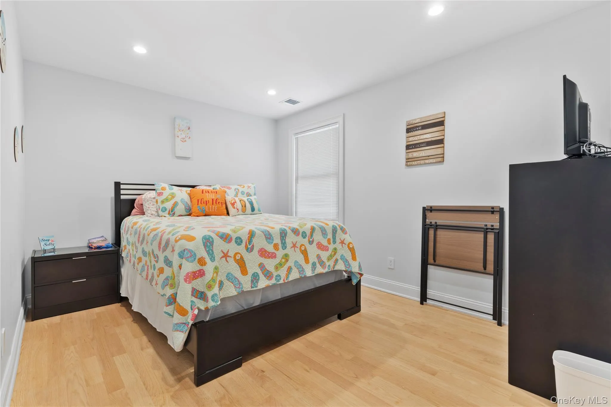 Bedroom with light wood-style floors and recessed lighting Bedroom with light wood-style floors and recessed lighting