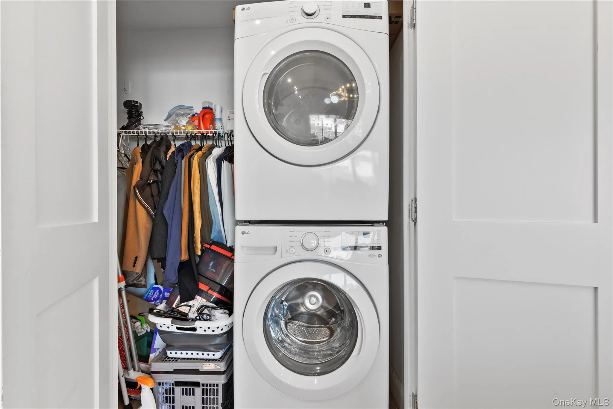 Laundry area with stacked washer and clothes dryer Laundry area with stacked washer and clothes dryer