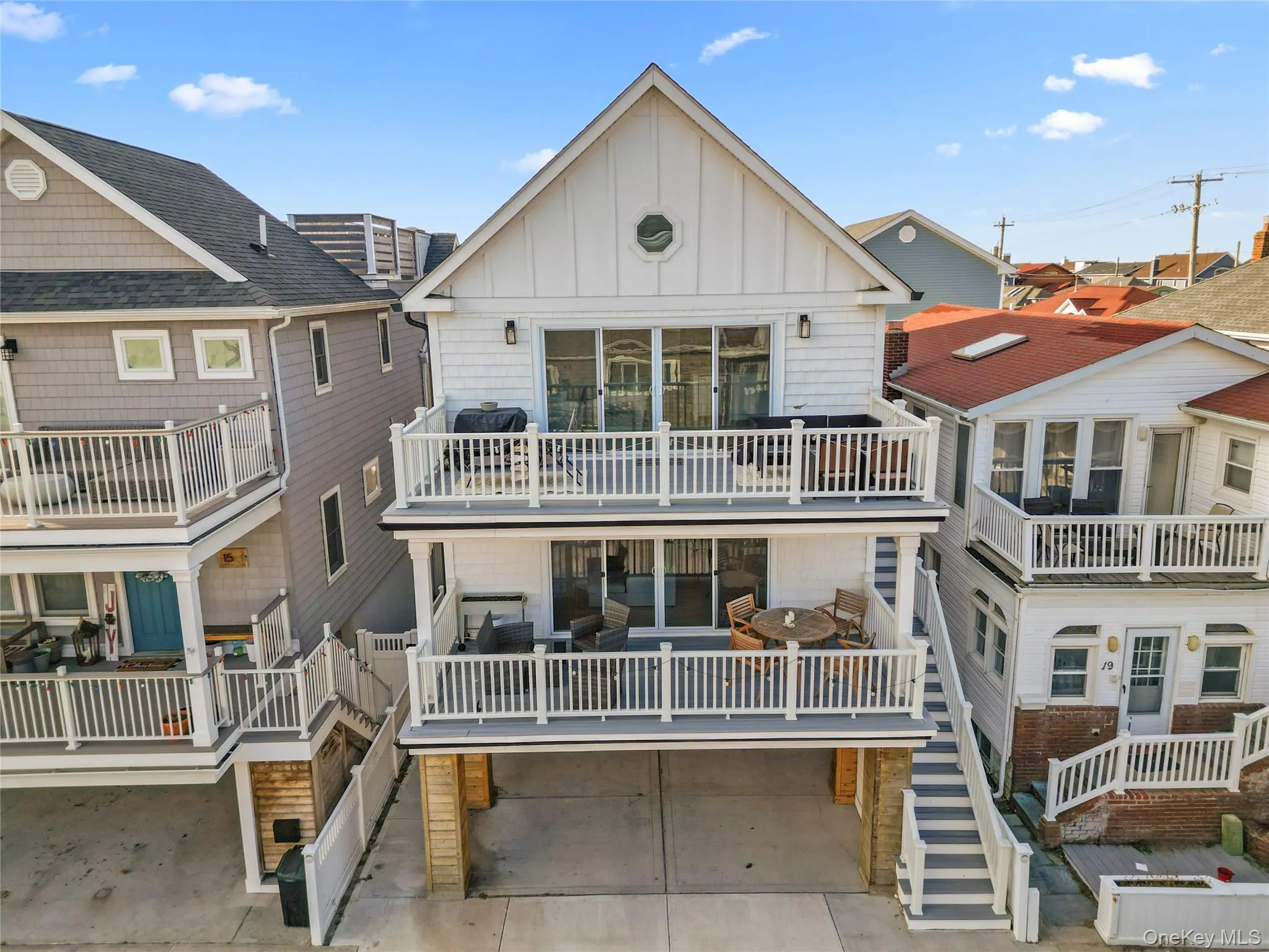 View of front facade featuring board and batten siding, outdoor lounge area, and a balcony View of front facade featuring board and batten siding, outdoor lounge area, and a balcony