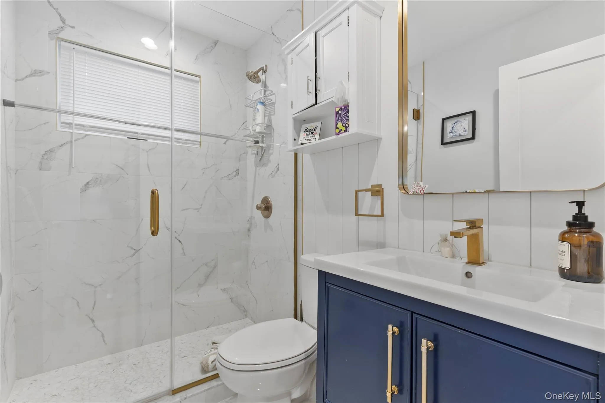 Full bathroom featuring a marble finish shower and vanity Full bathroom featuring a marble finish shower and vanity