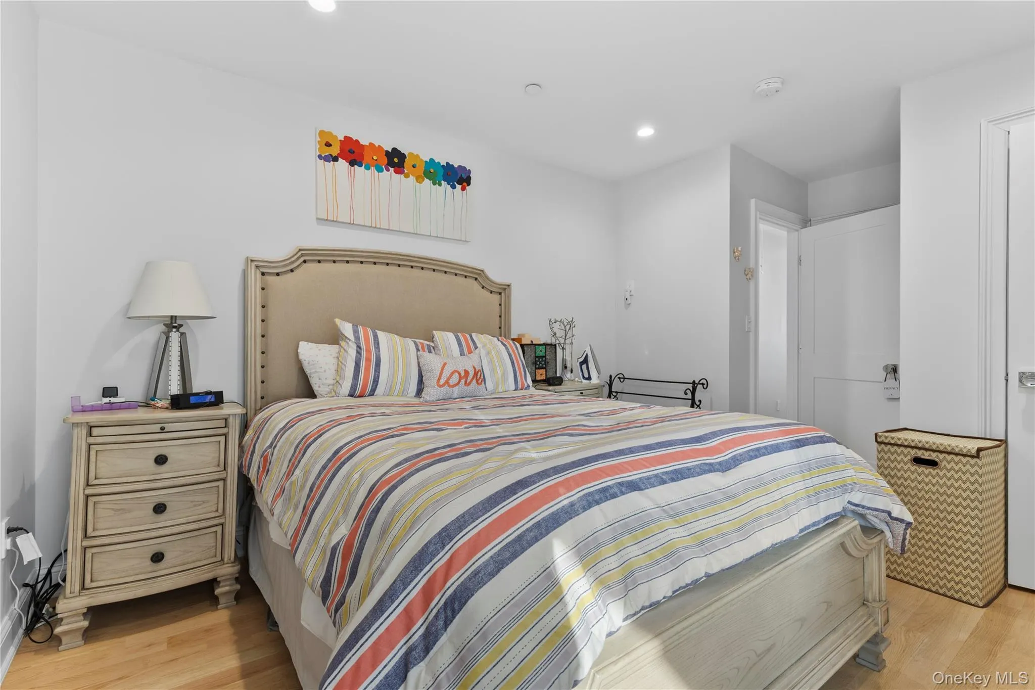 Bedroom featuring light wood-style floors and recessed lighting Bedroom featuring light wood-style floors and recessed lighting