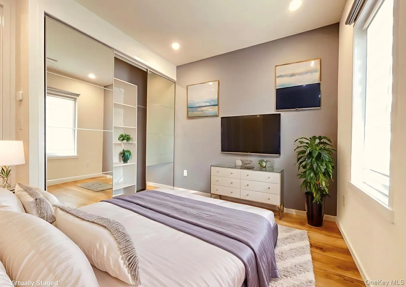 Bedroom featuring light wood finished floors and recessed lighting Bedroom featuring light wood finished floors and recessed lighting