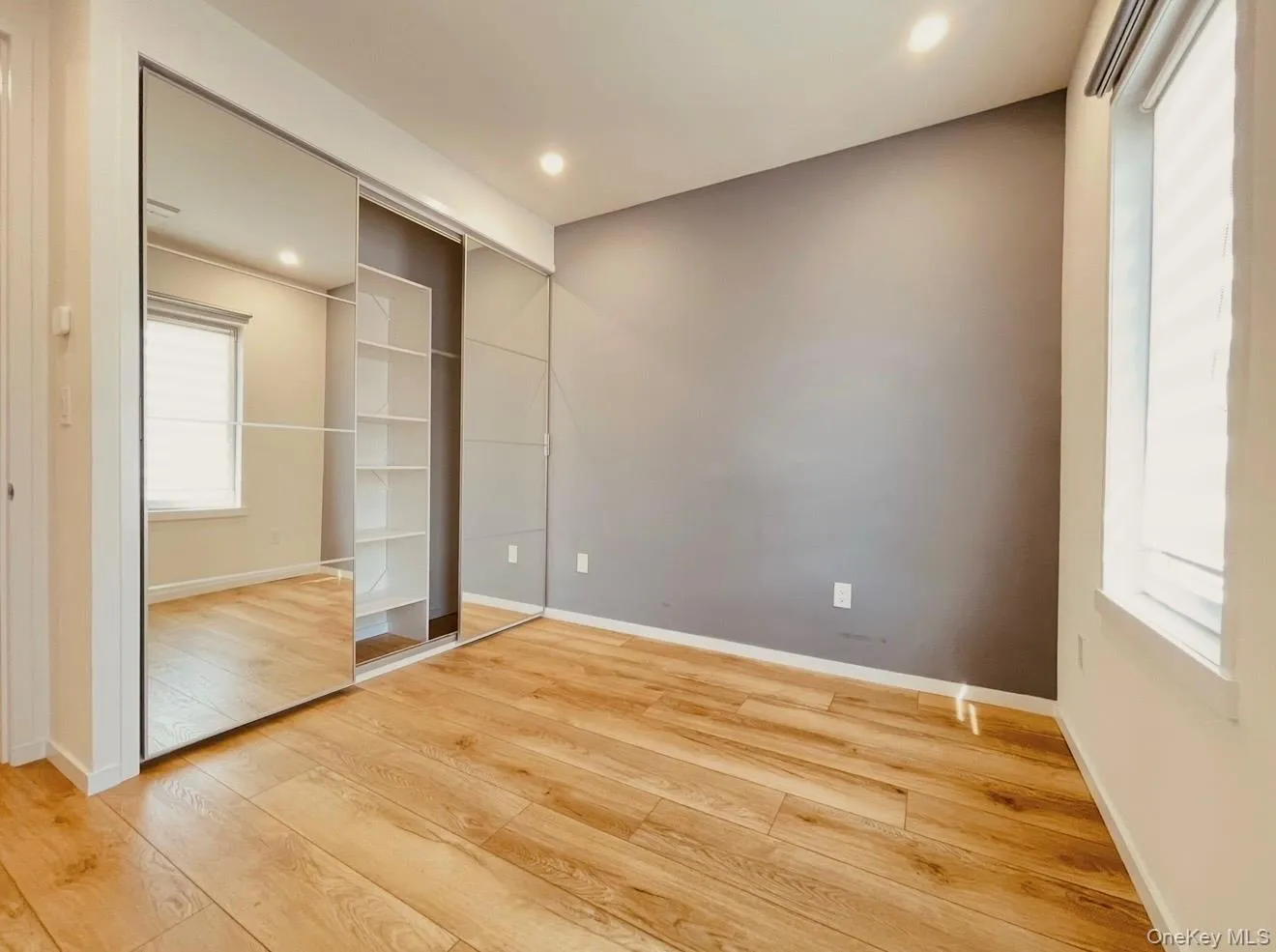 Unfurnished bedroom featuring hardwood / wood-style floors and recessed lighting Unfurnished bedroom featuring hardwood / wood-style floors and recessed lighting