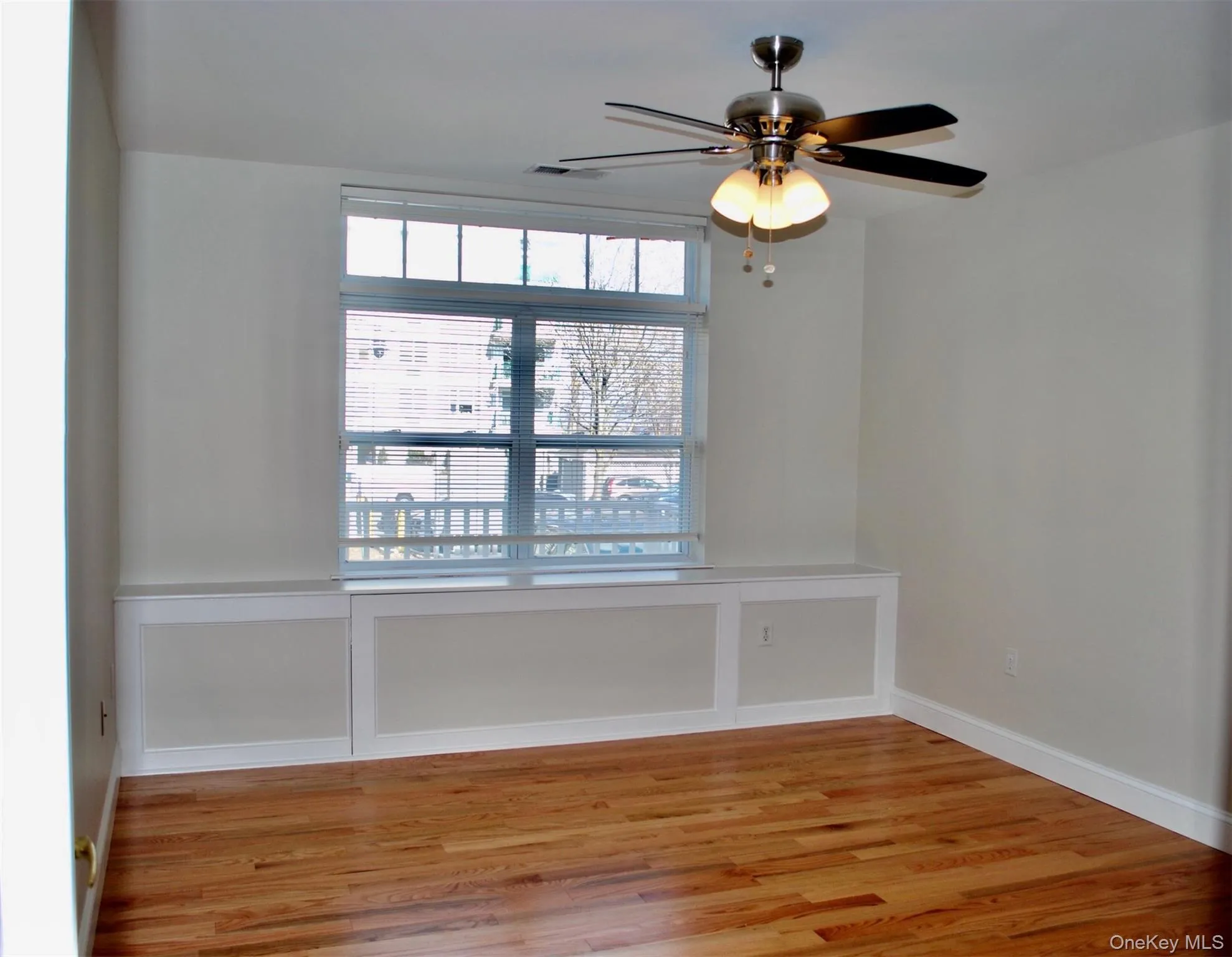 Spare room featuring light wood-type flooring and a ceiling fan Spare room featuring light wood-type flooring and a ceiling fan