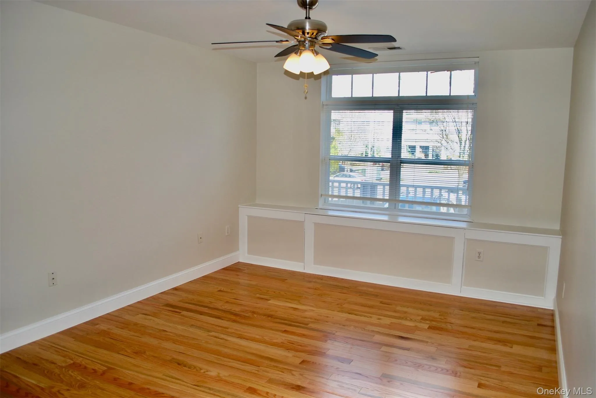 Unfurnished room with light wood-style flooring and ceiling fan Unfurnished room with light wood-style flooring and ceiling fan