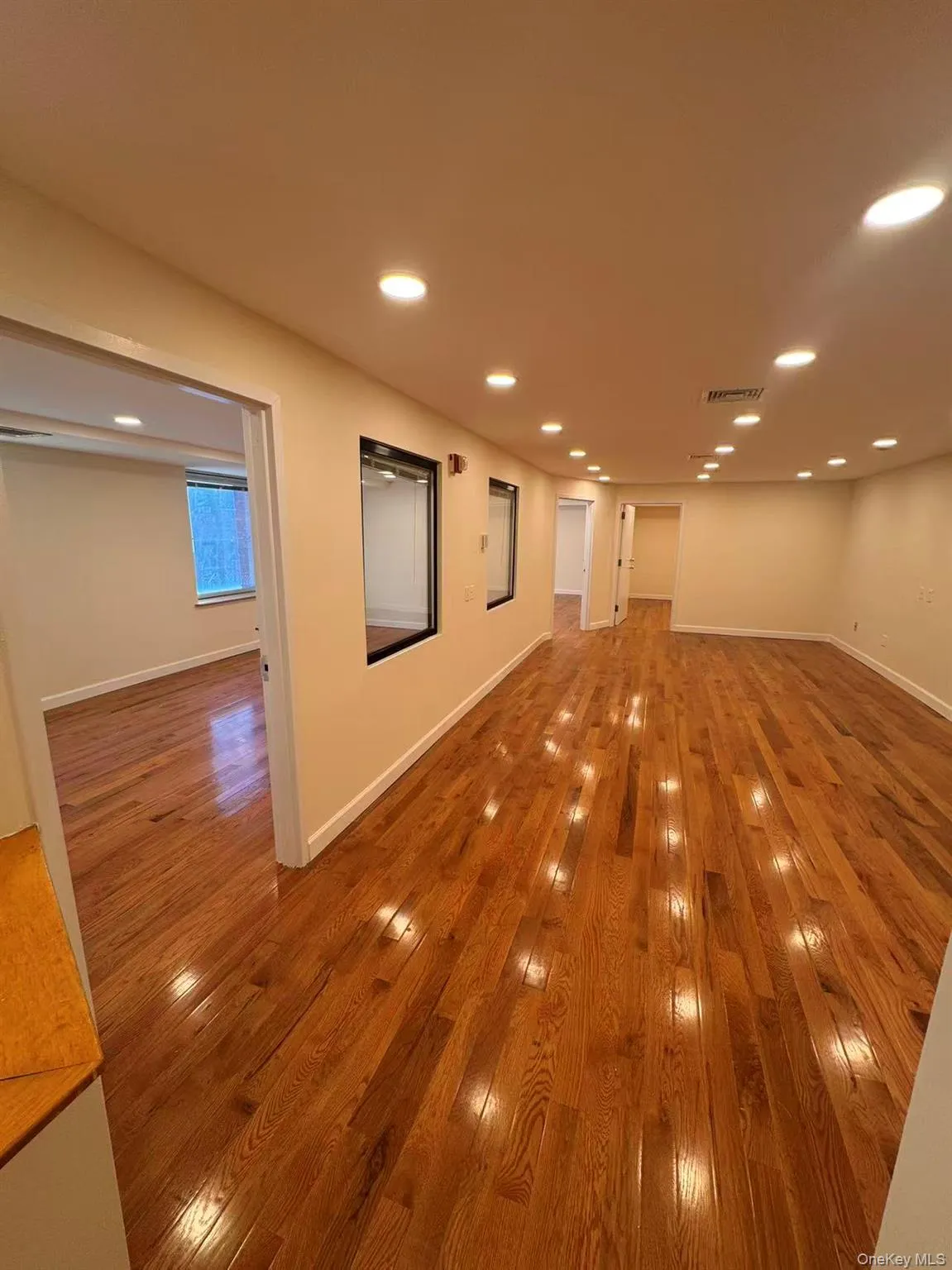 Empty room featuring hardwood / wood-style floors and recessed lighting Empty room featuring hardwood / wood-style floors and recessed lighting