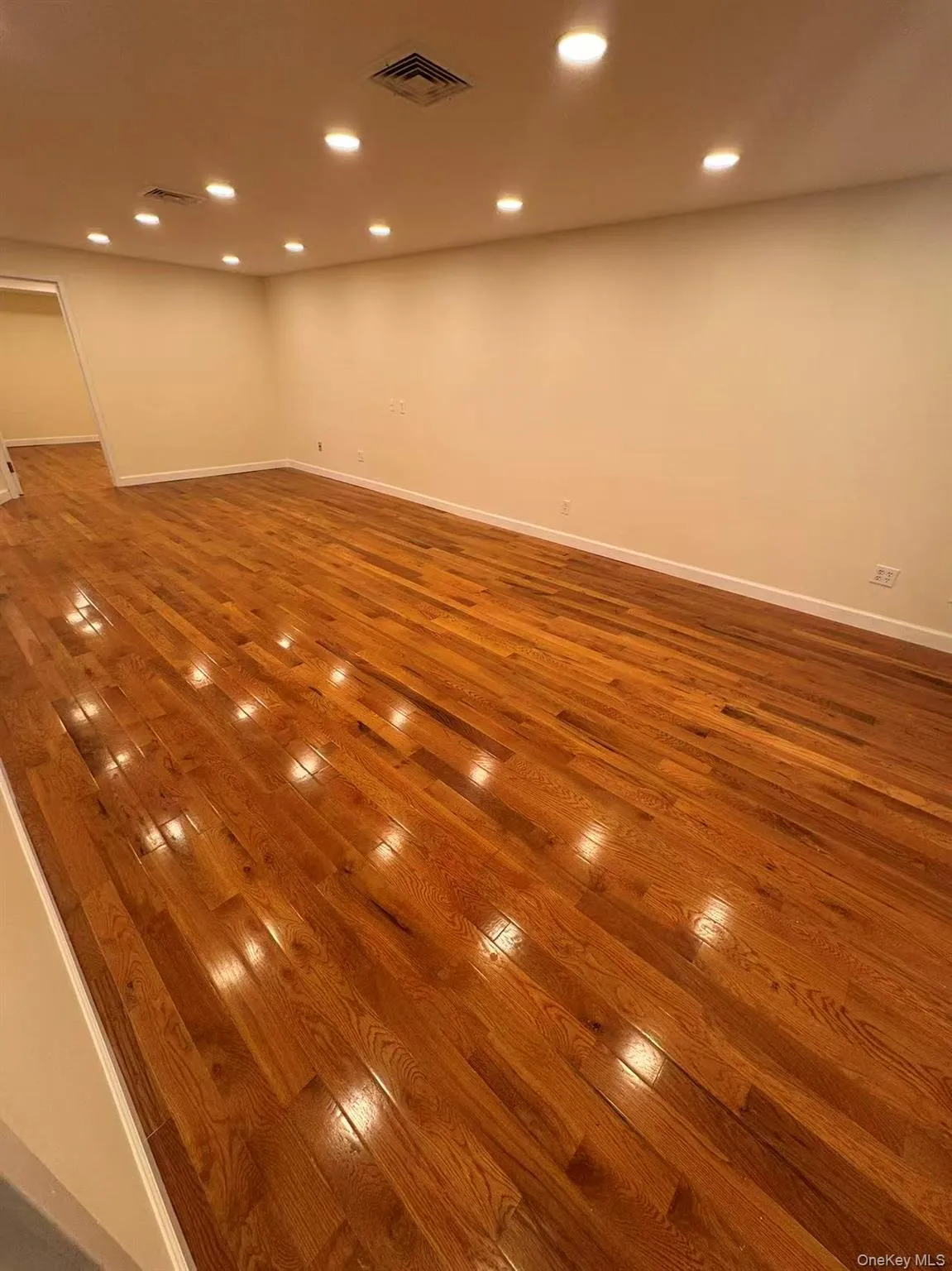 Unfurnished room featuring recessed lighting and wood finished floors Unfurnished room featuring recessed lighting and wood finished floors