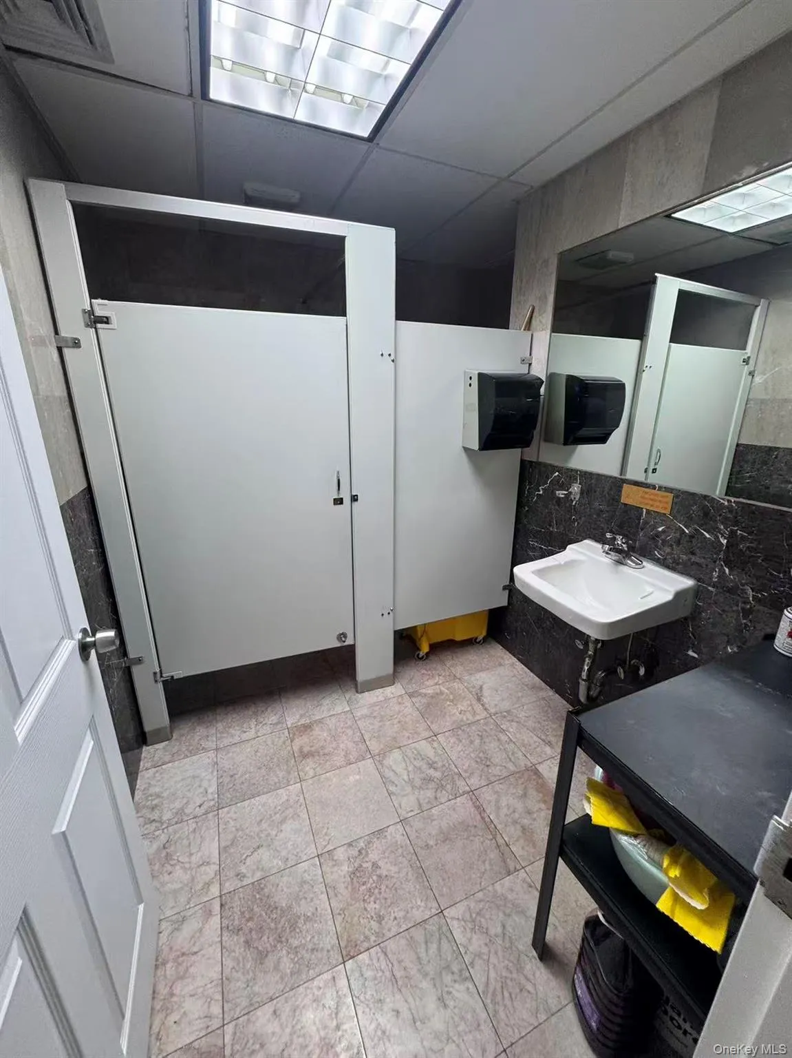 Bathroom with a sink and a paneled ceiling Bathroom with a sink and a paneled ceiling