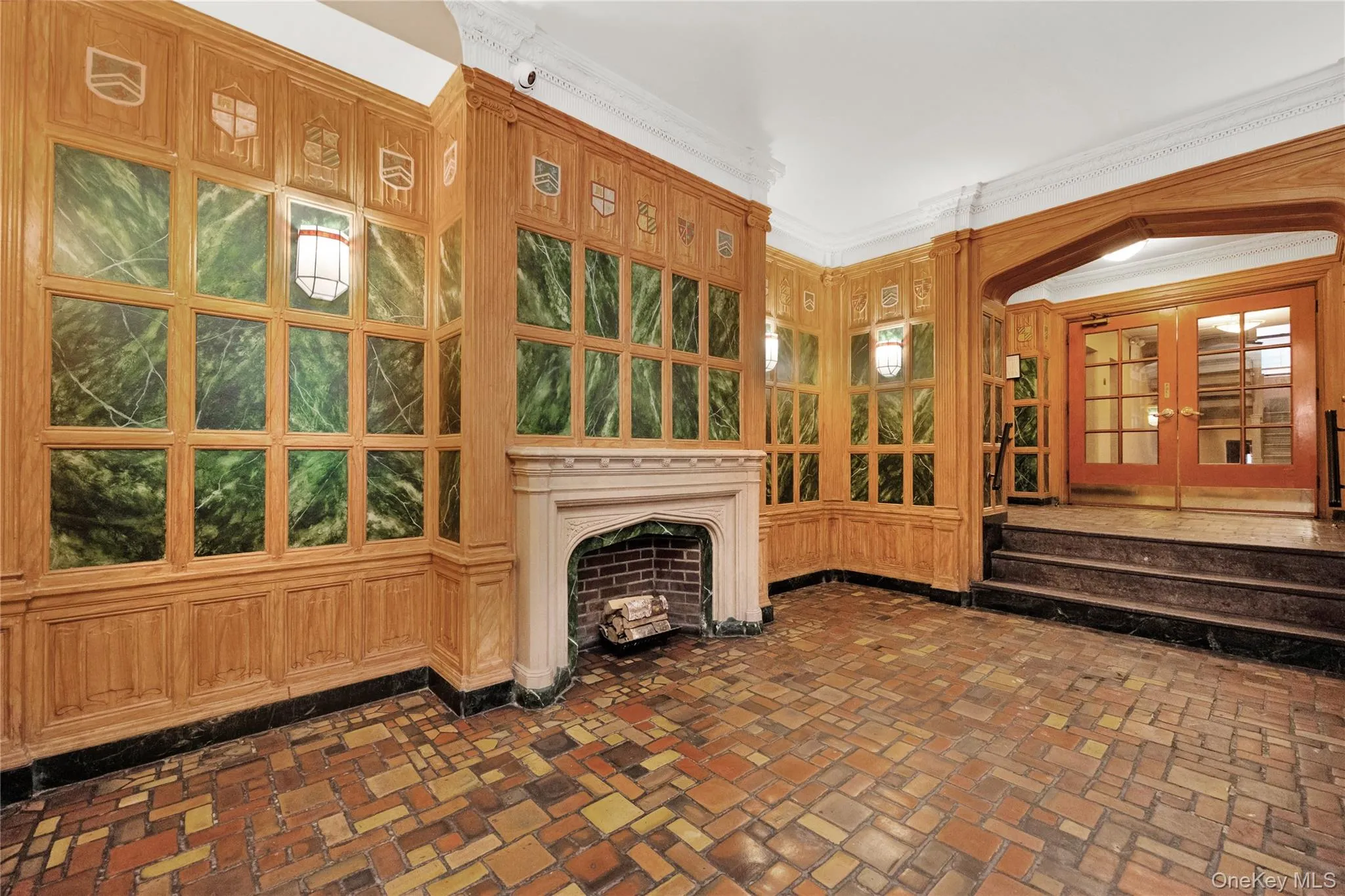 Unfurnished living room with brick floors, a fireplace, and crown molding Unfurnished living room with brick floors, a fireplace, and crown molding